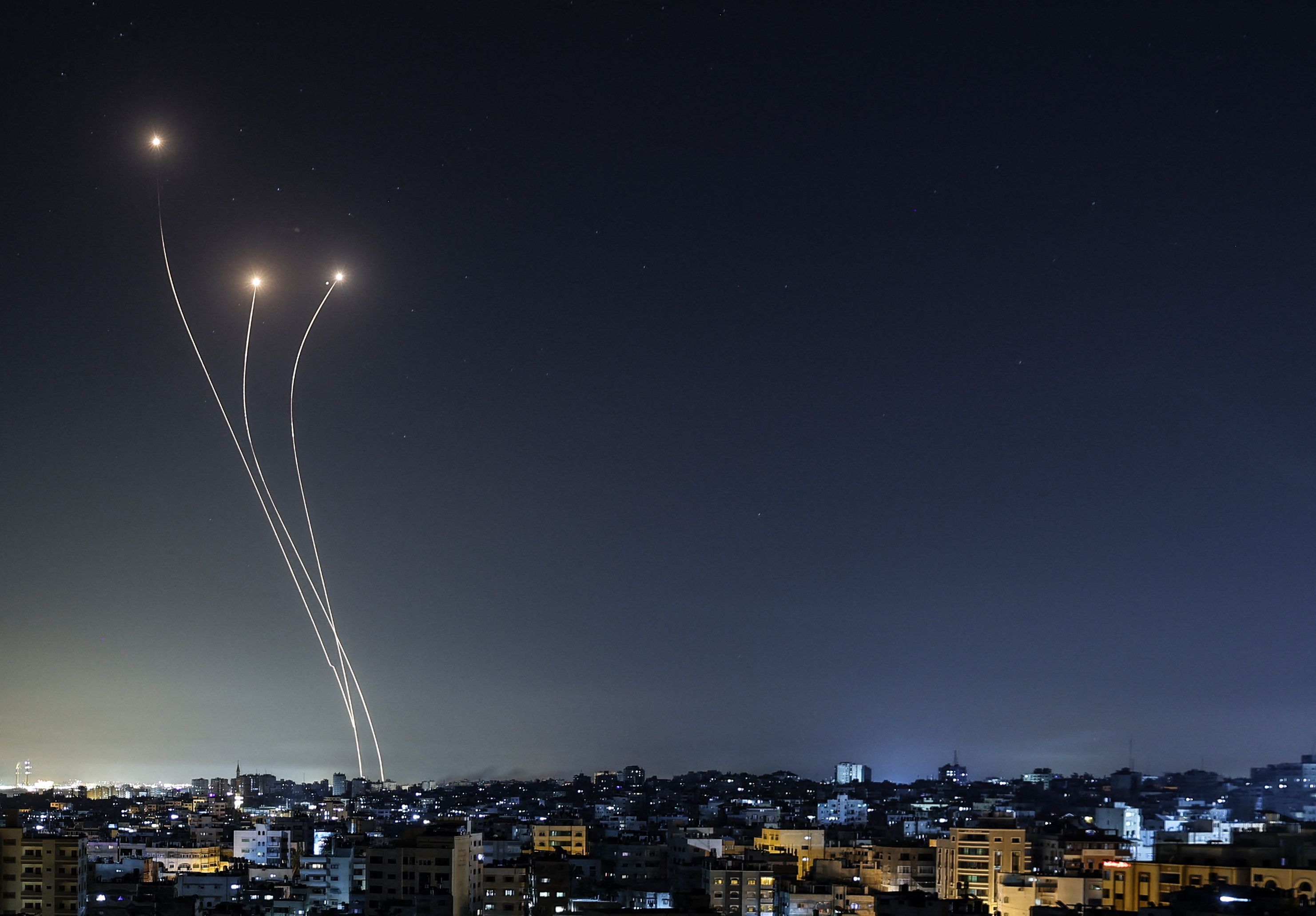 A streak of light appears as Israel's Iron Dome anti-missile system intercepts rockets launched from the Gaza Strip, early on May 17
