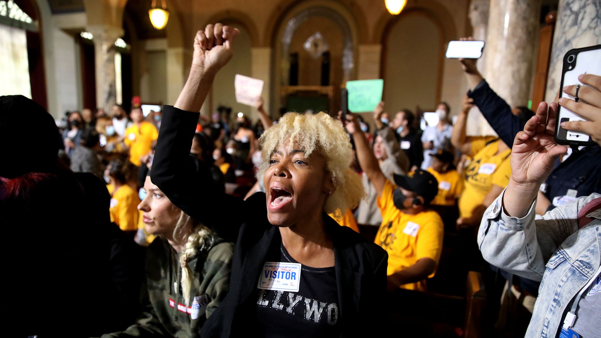 Protestors at the Los Angeles City Council meeting in the Council Chamber at Los Angeles City Hall