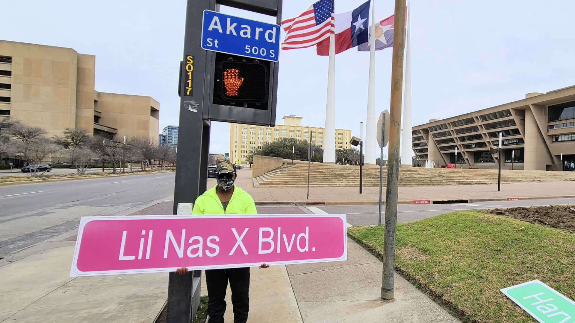 A man with a pink Lil Nas X Blvd sign