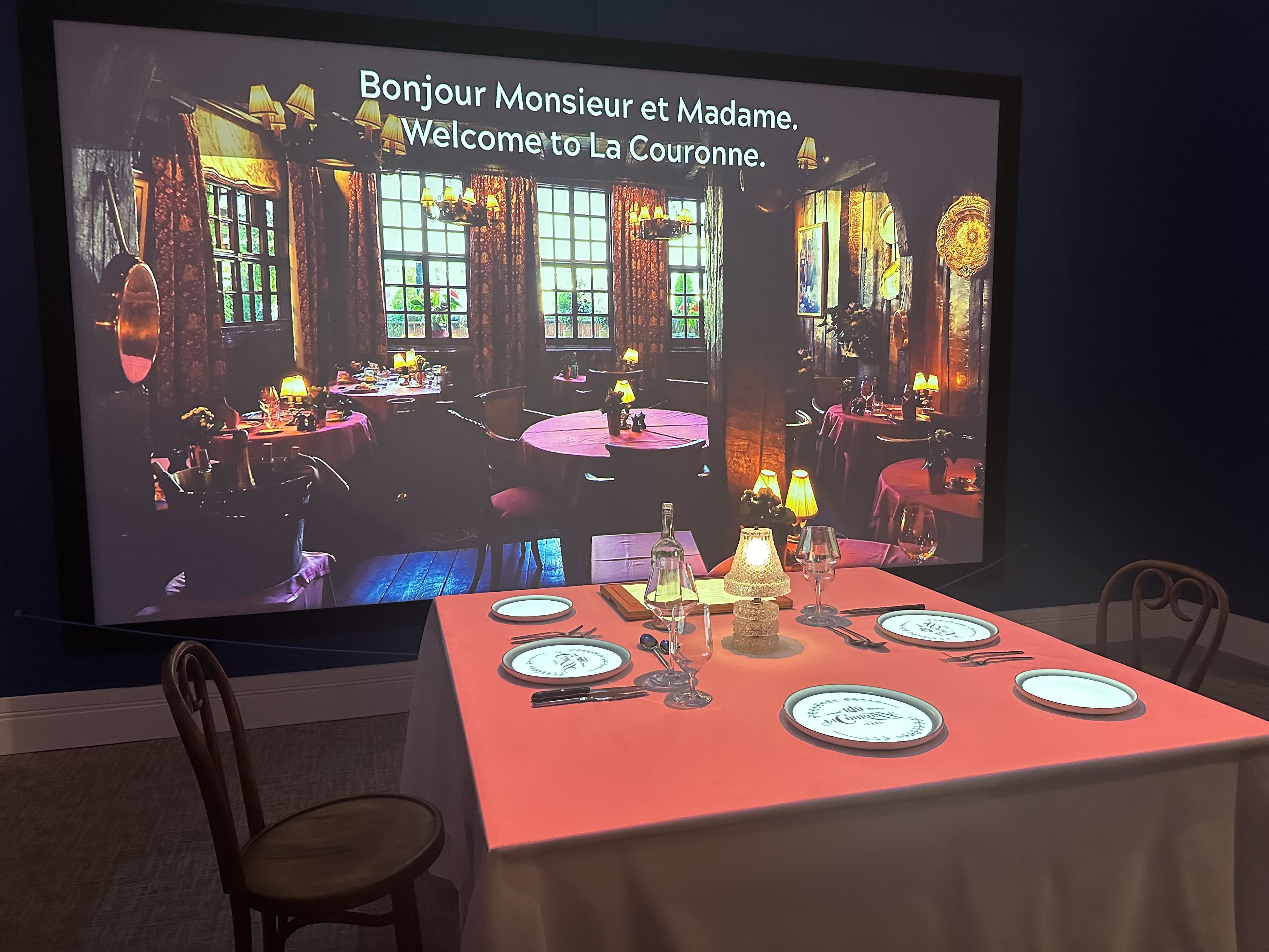 A dining table in front of a big pic of a french restaurant 