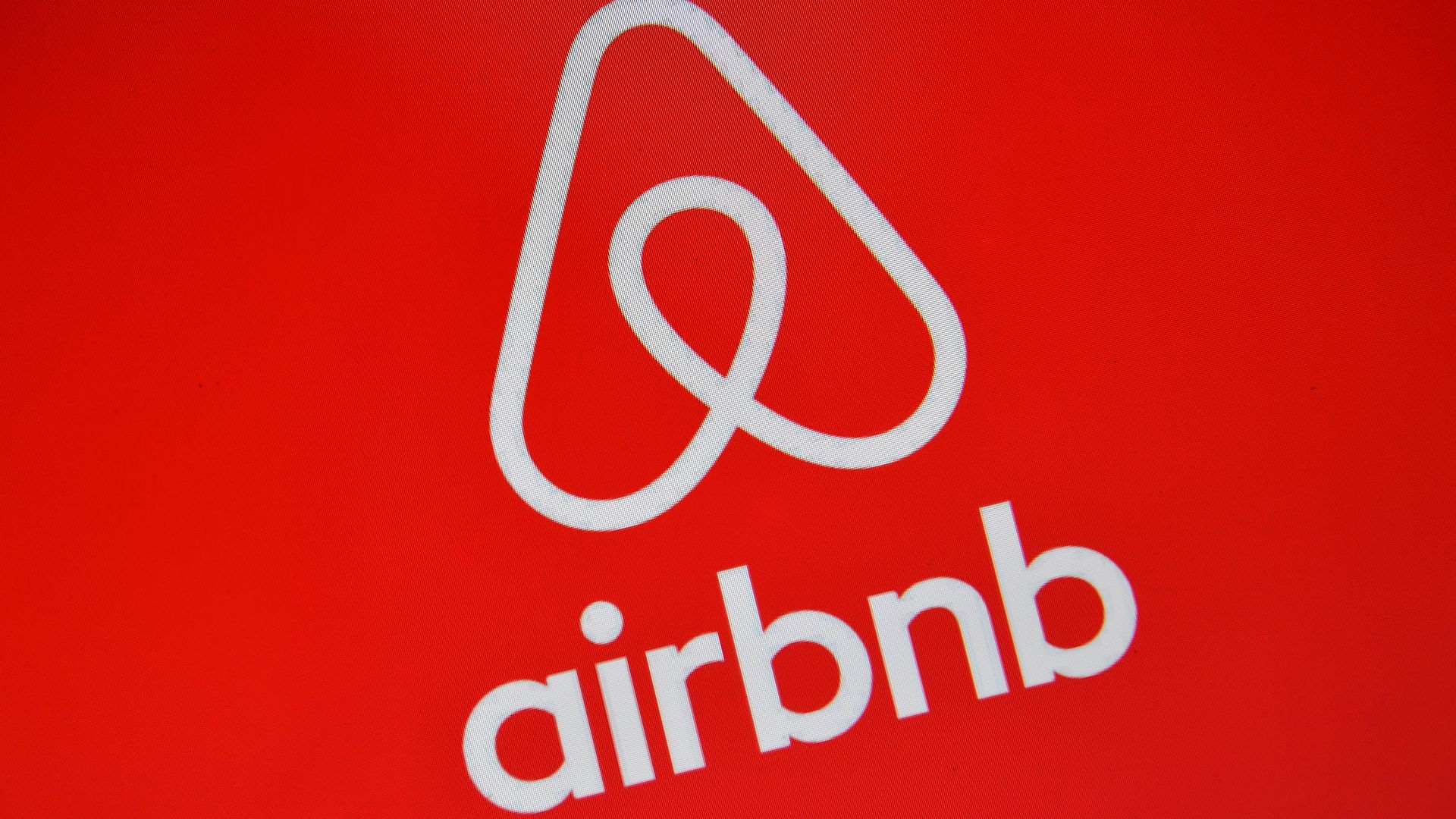 Airbnb logo on a red background
