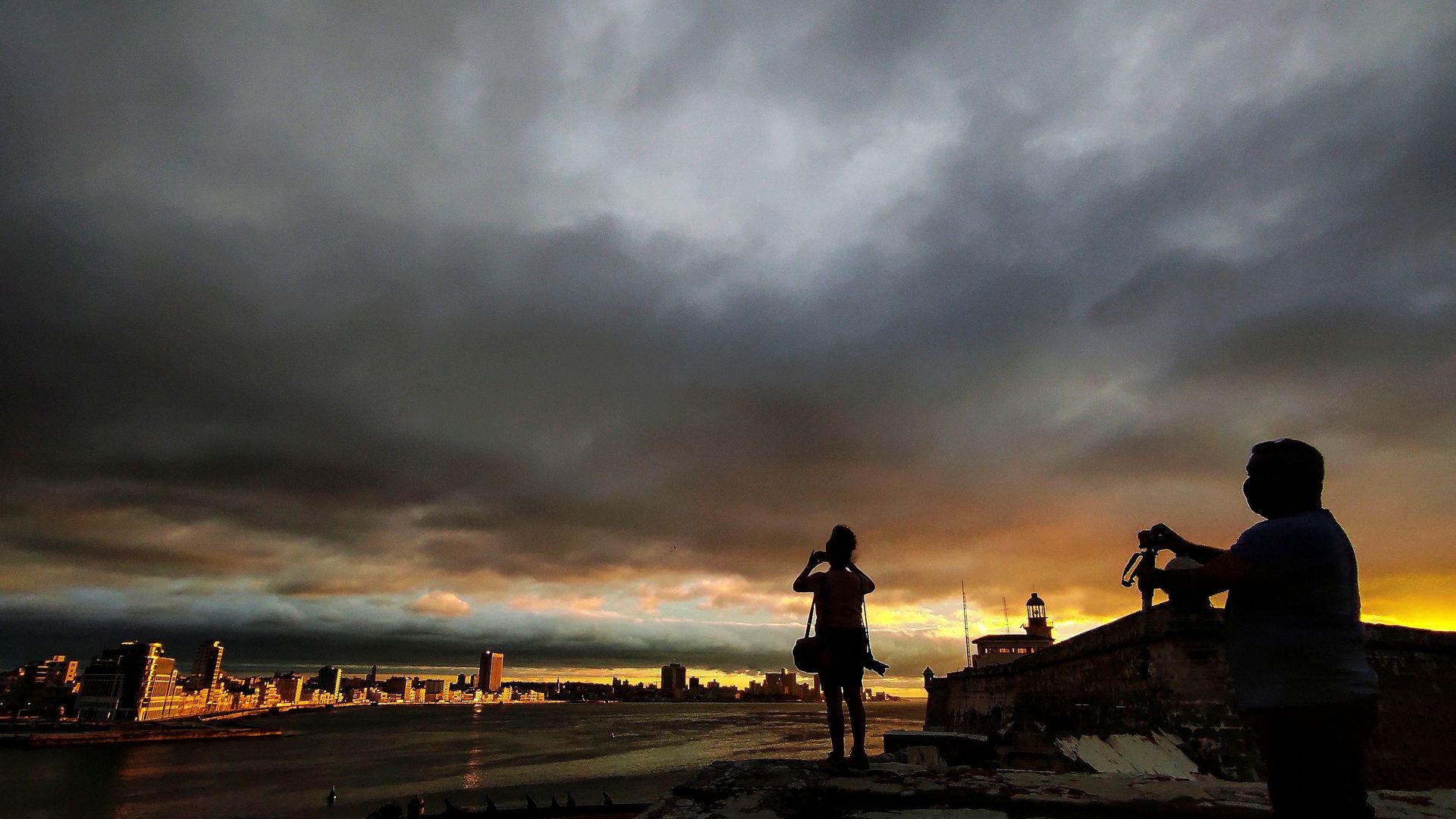 Photographers take pictures of the sunset before the passage of Tropical Storm Elsa in Havana, on July 5