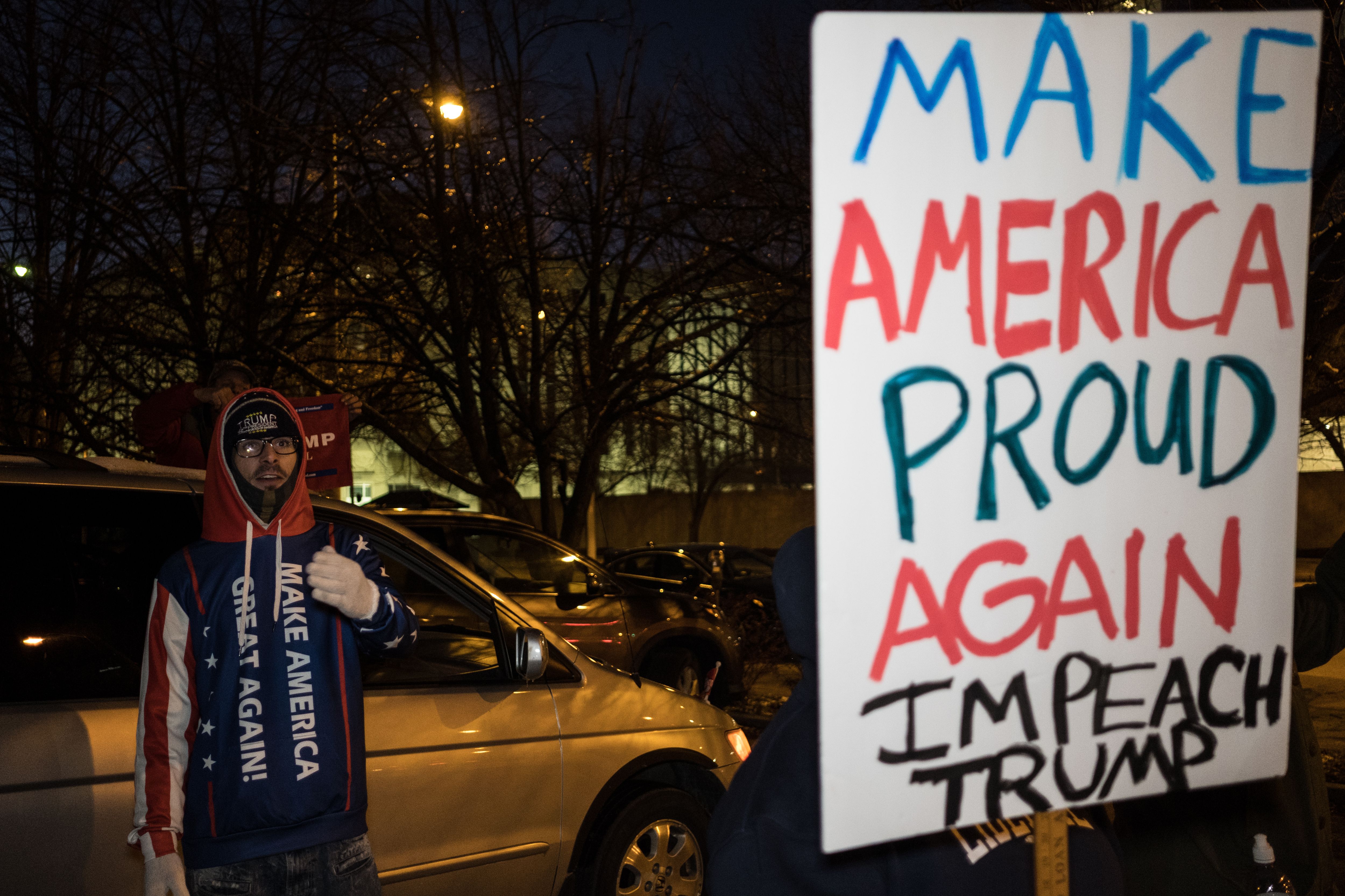 A Trump supporter counters pro-impeachment protesters in Dayton. 