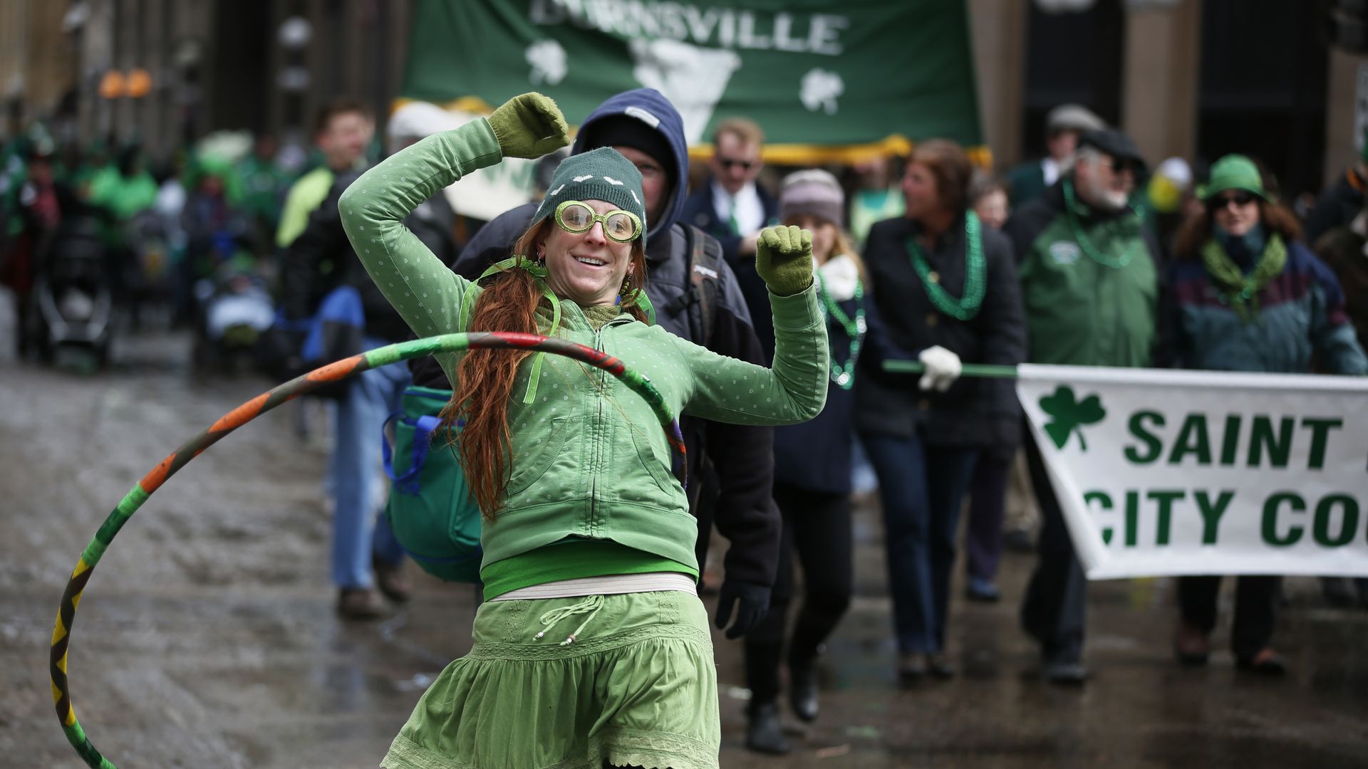 A marcher in a parade does the hoola hoop