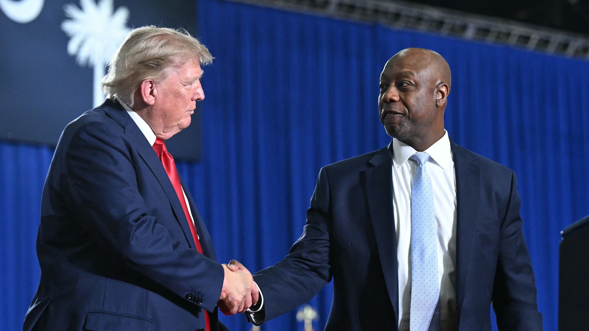 President Trump and National Republican Senatorial Committee Chair Tim Scott shake hands during a rally for Sen. Darline Graham in Myrtle Beach, S.C., on Aug. 21.