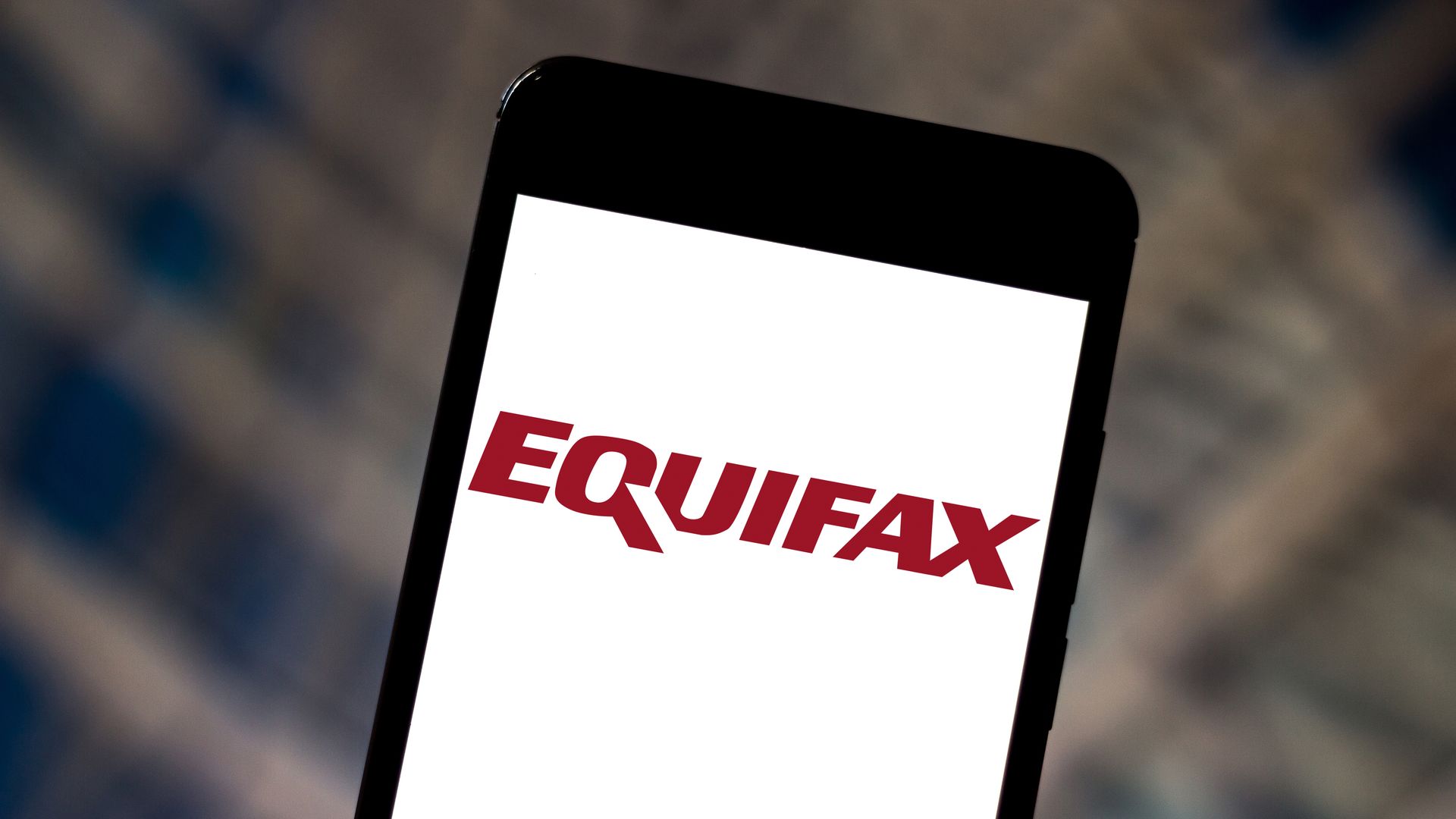 This image shows a phone with the Equifax logo.