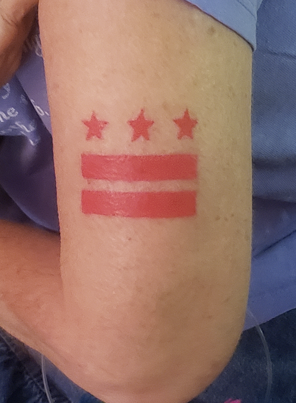 Upper arm tattoo of D.C. flag