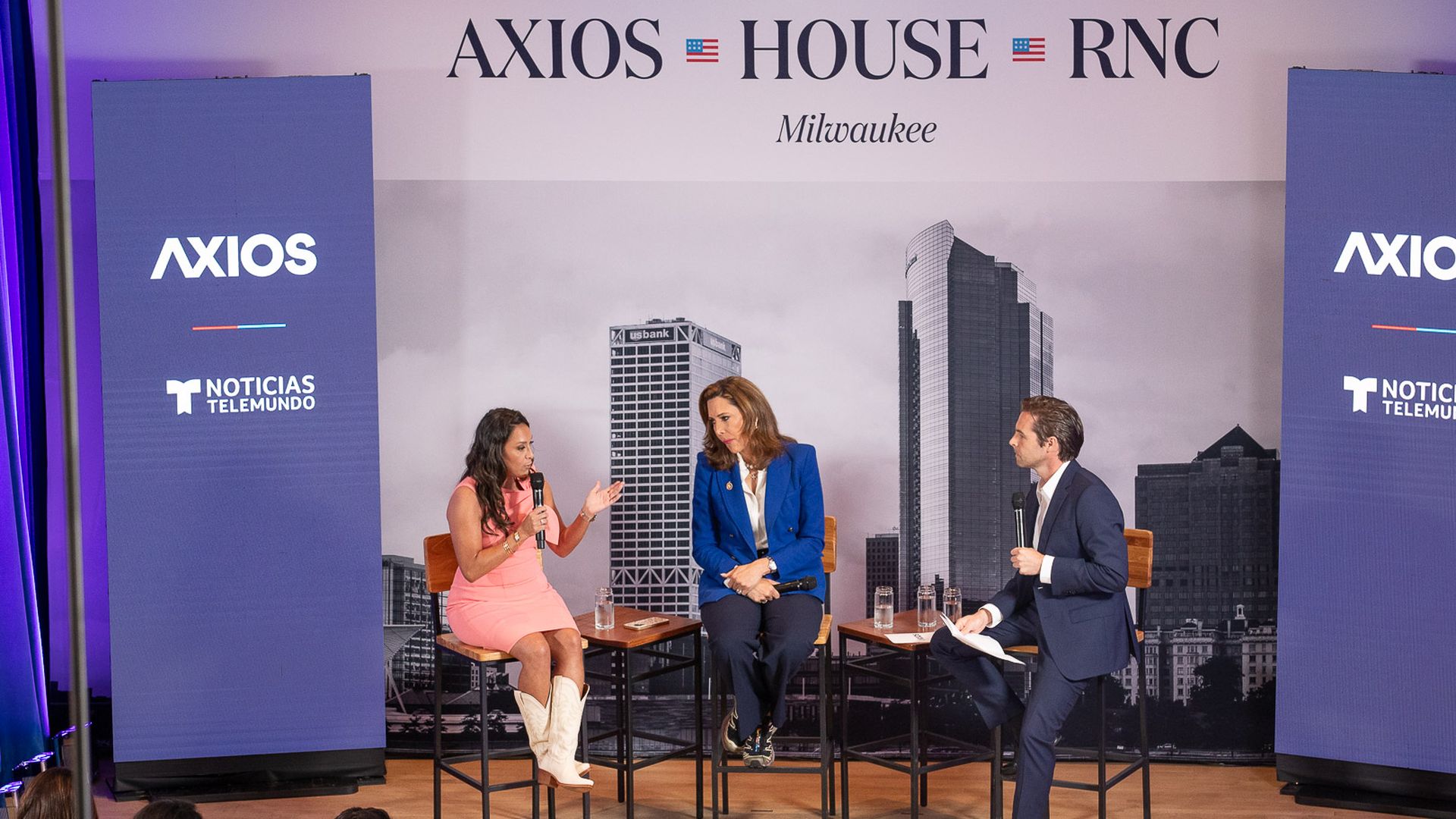 U.S. Rep. Monica De La Cruz (R-Texas) and U.S. Rep. María Elvira Salazar (R-Fla.) speak with moderator Julio Vaqueiro at an Axios House event at the RNC.