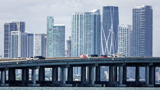 Tall buildings in the background and a causeway in front 