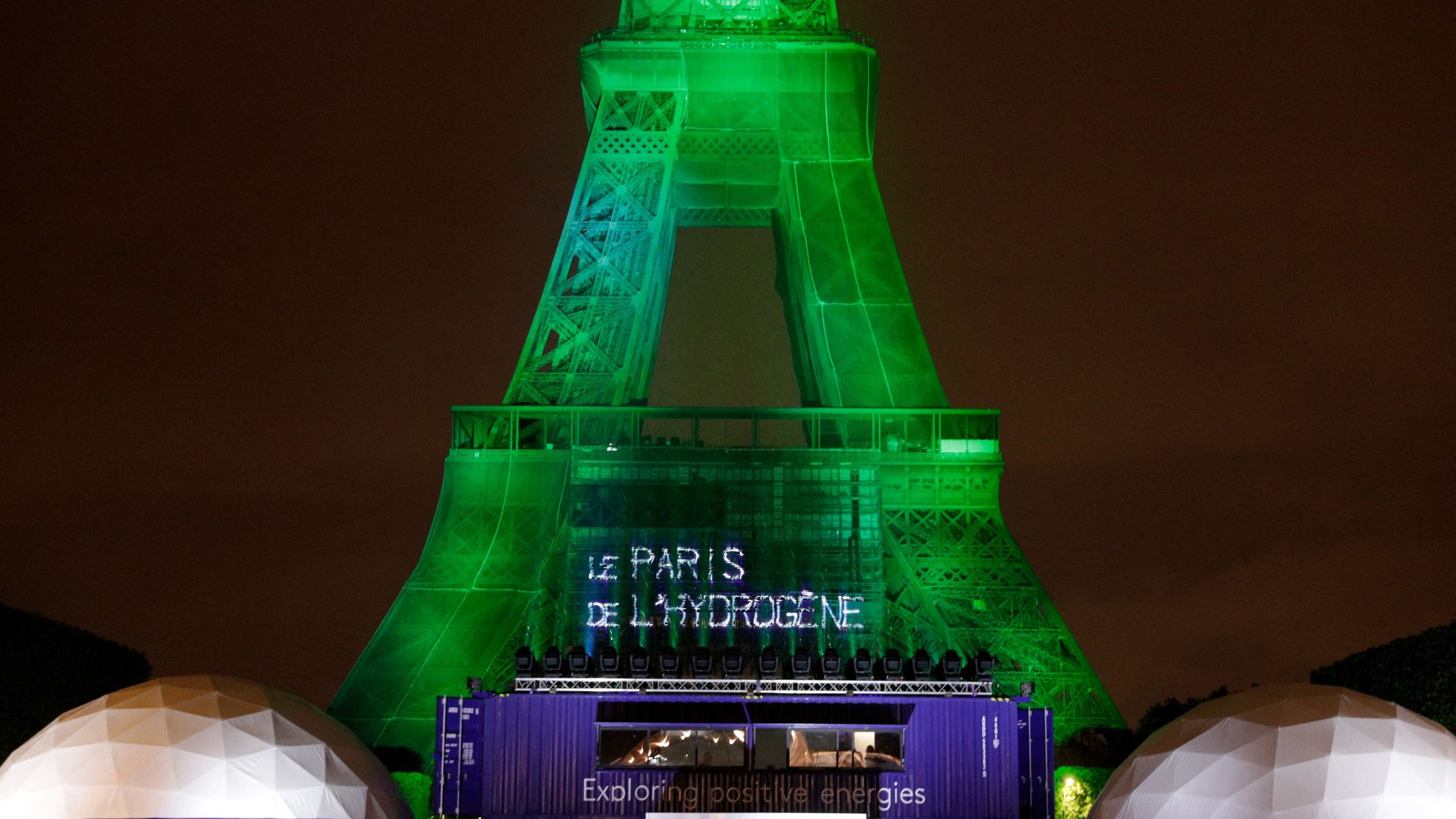 Eiffel tower lit in green with a message about hydrogen power.