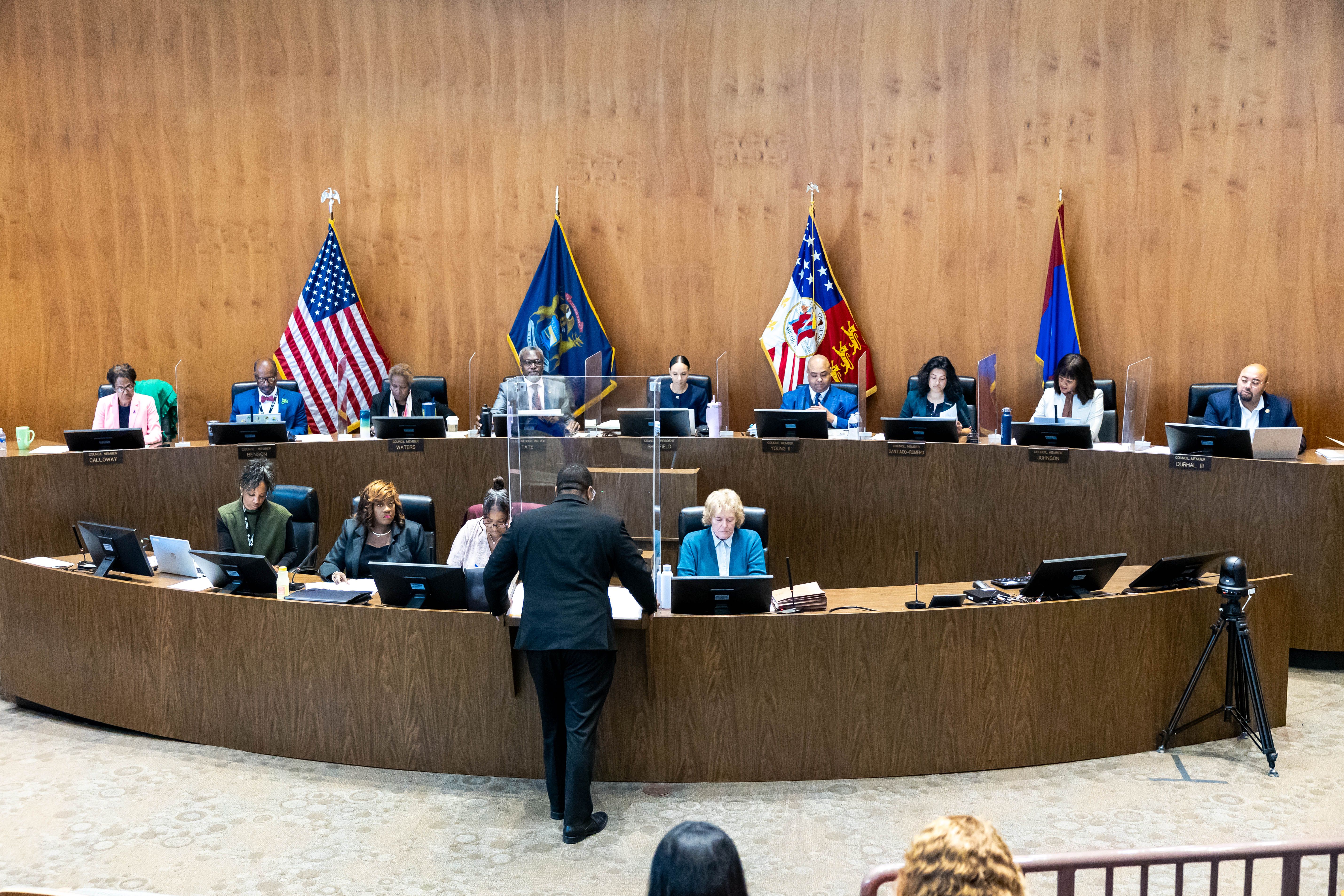 City council members are pictured at their seats in city hall