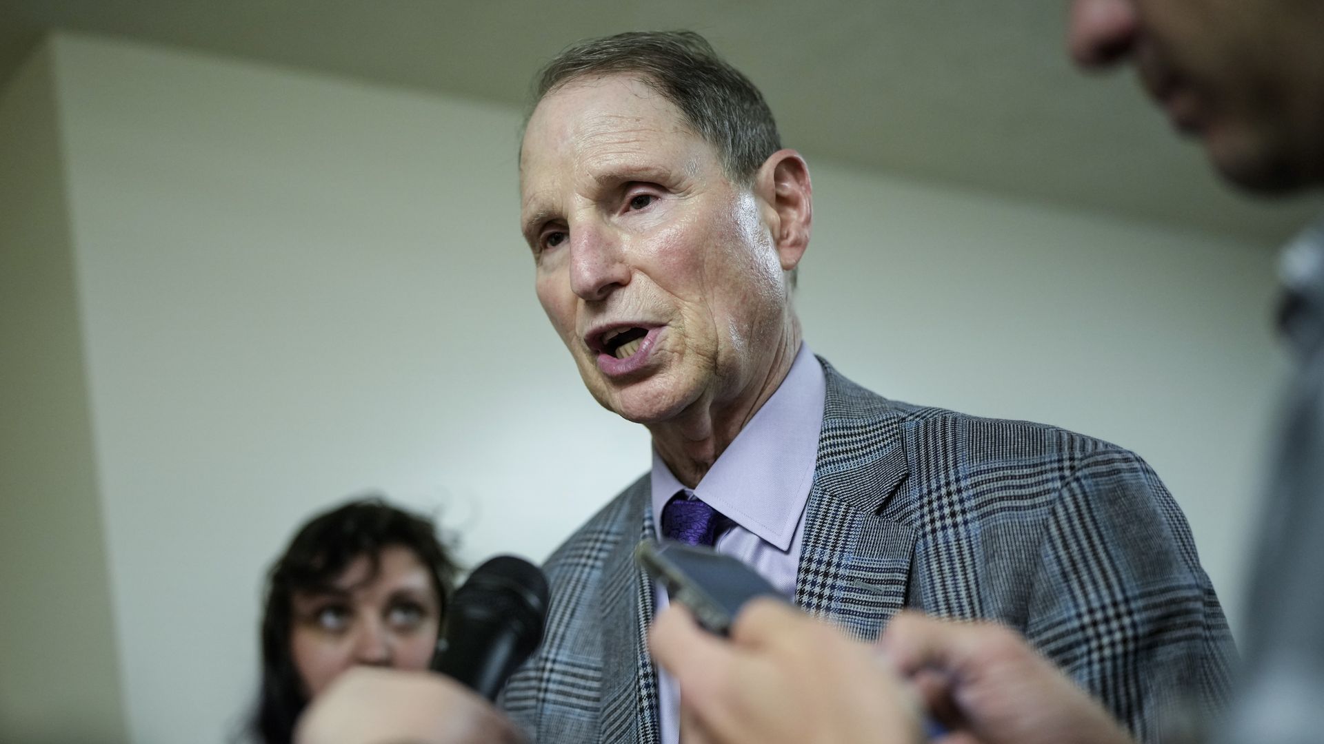Ron Wyden talks to reporters