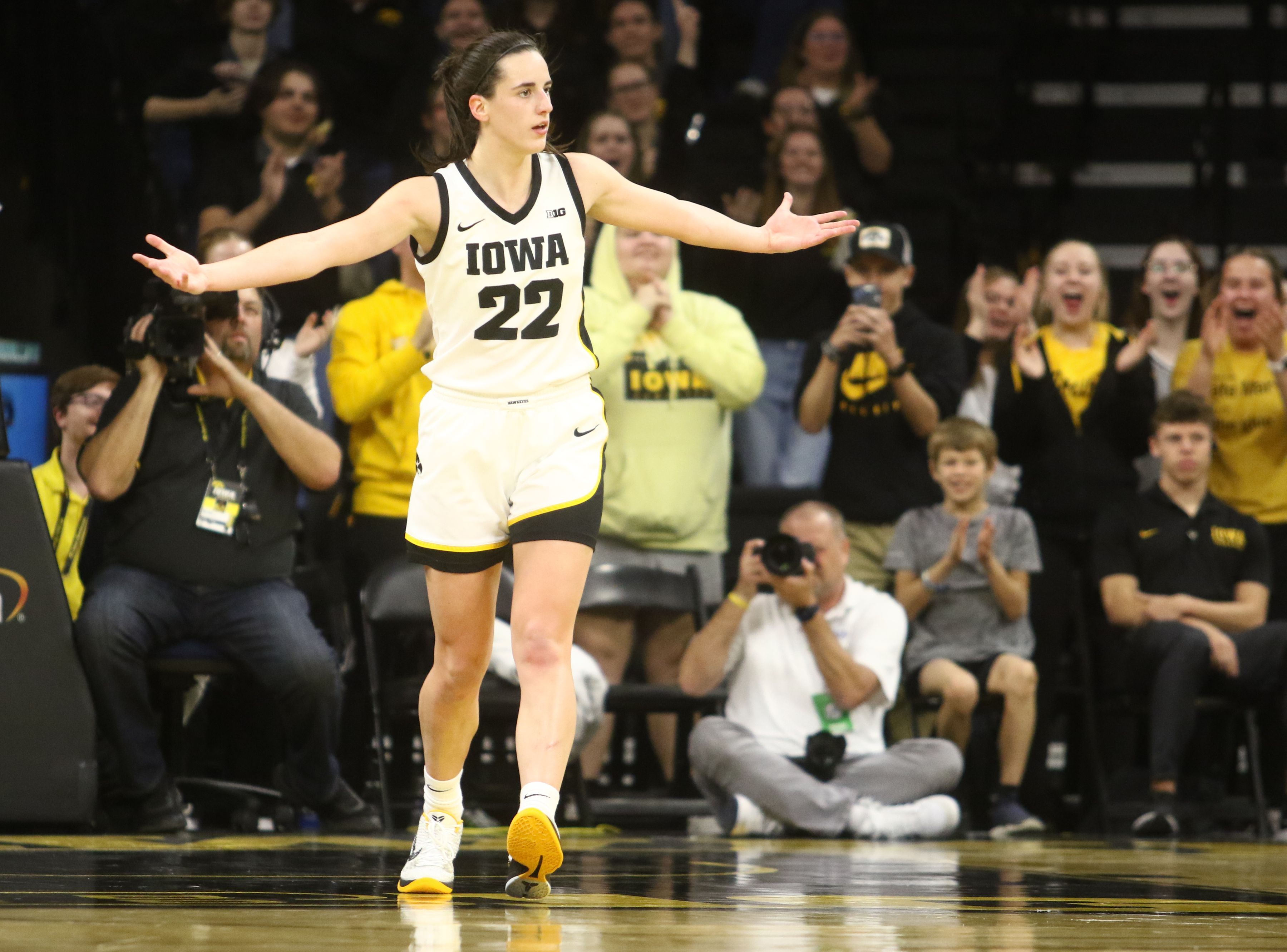 Photo of a woman stretching her arms out during a basketball game