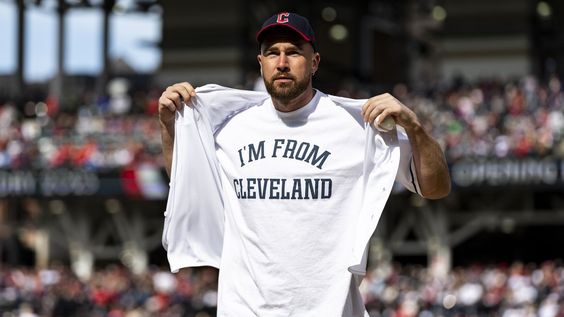 Travis Kelce reveals an "I'm From Cleveland" shirt on the mound at the Cleveland Guardians game.