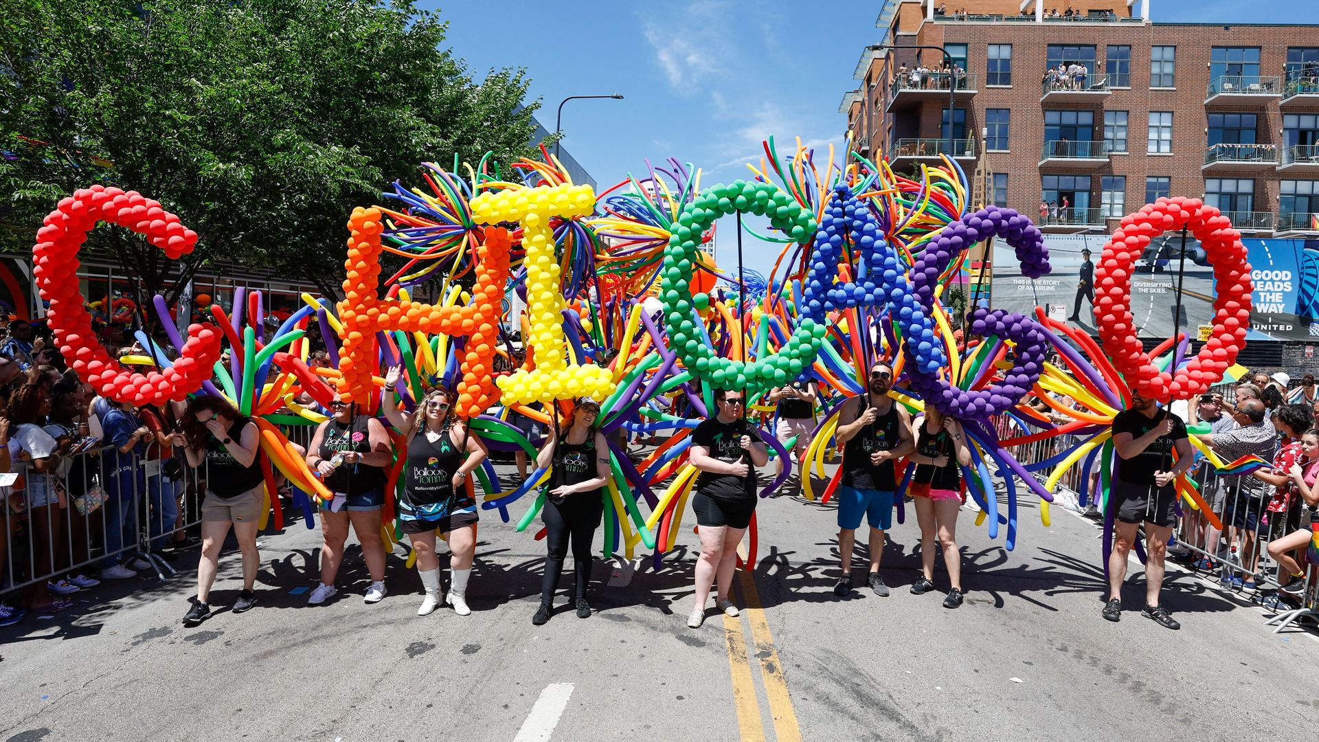 Participants carry balloons spelling out "Chicago" during the 51st LGBTQ Pride Parade in Chicago, Illinois, on June 26, 2022.