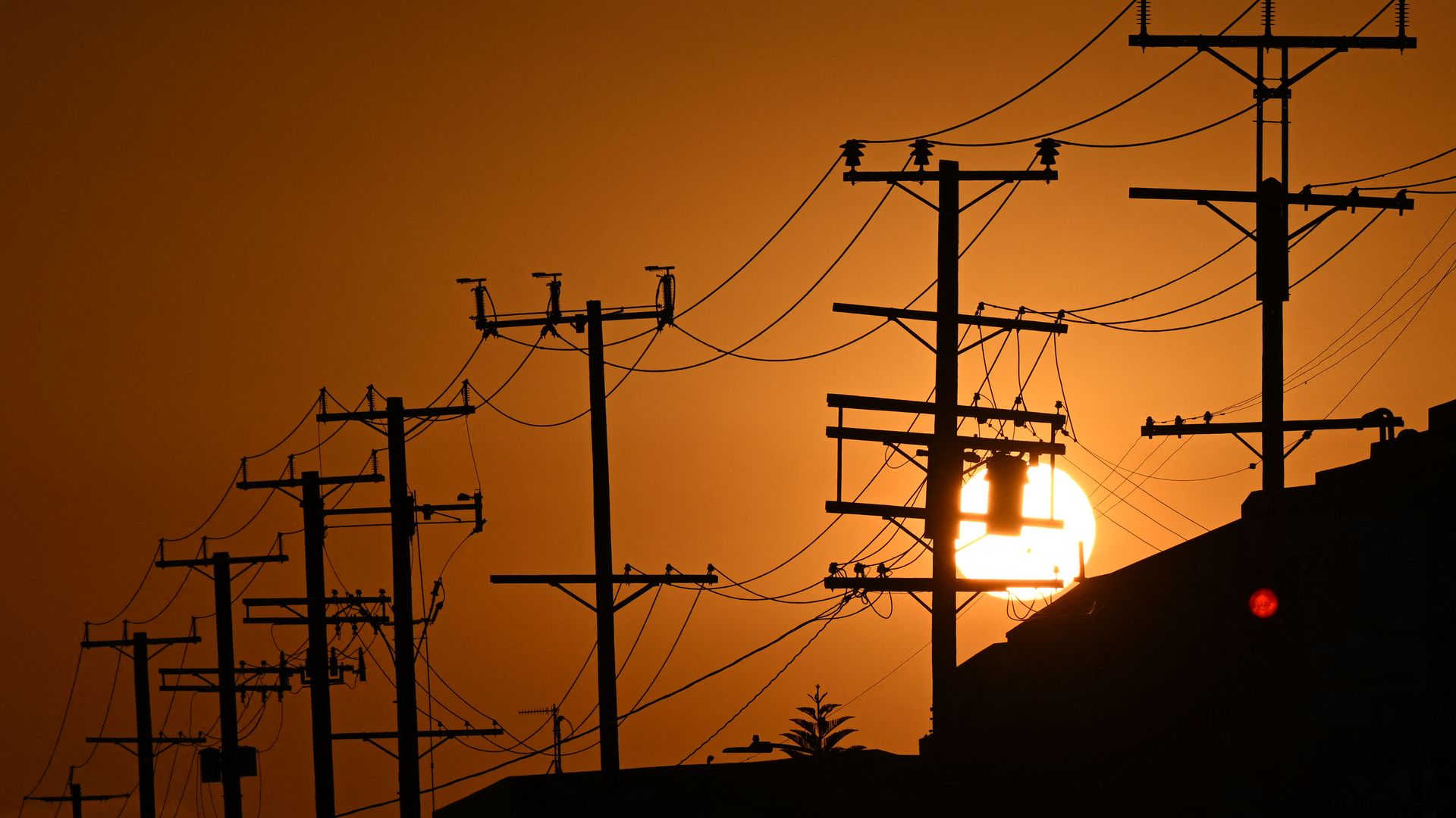 Picture of the sun behind power lines in Los Angeles, California.