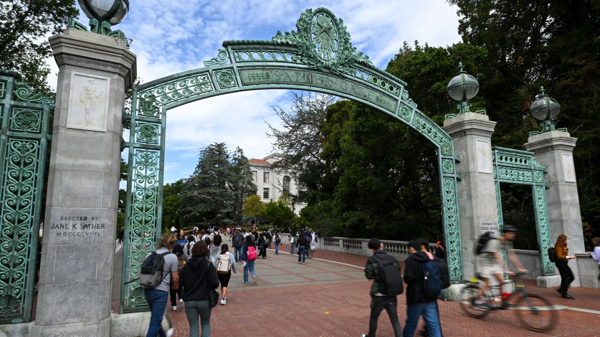 Photo of the green gate to the UC Berkeley campus as students walk through