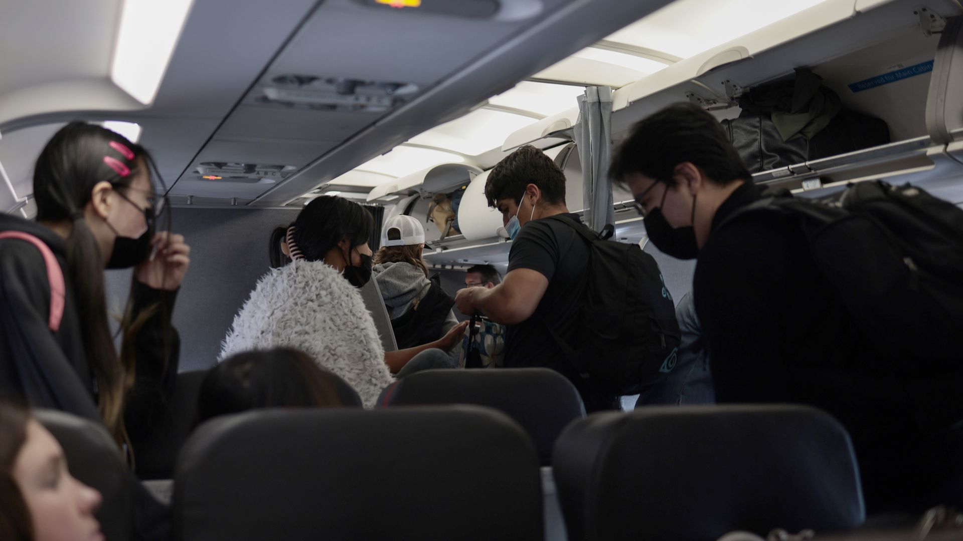 Passengers deplane from an airplane after landing at the Albuquerque International Sunport on November 24