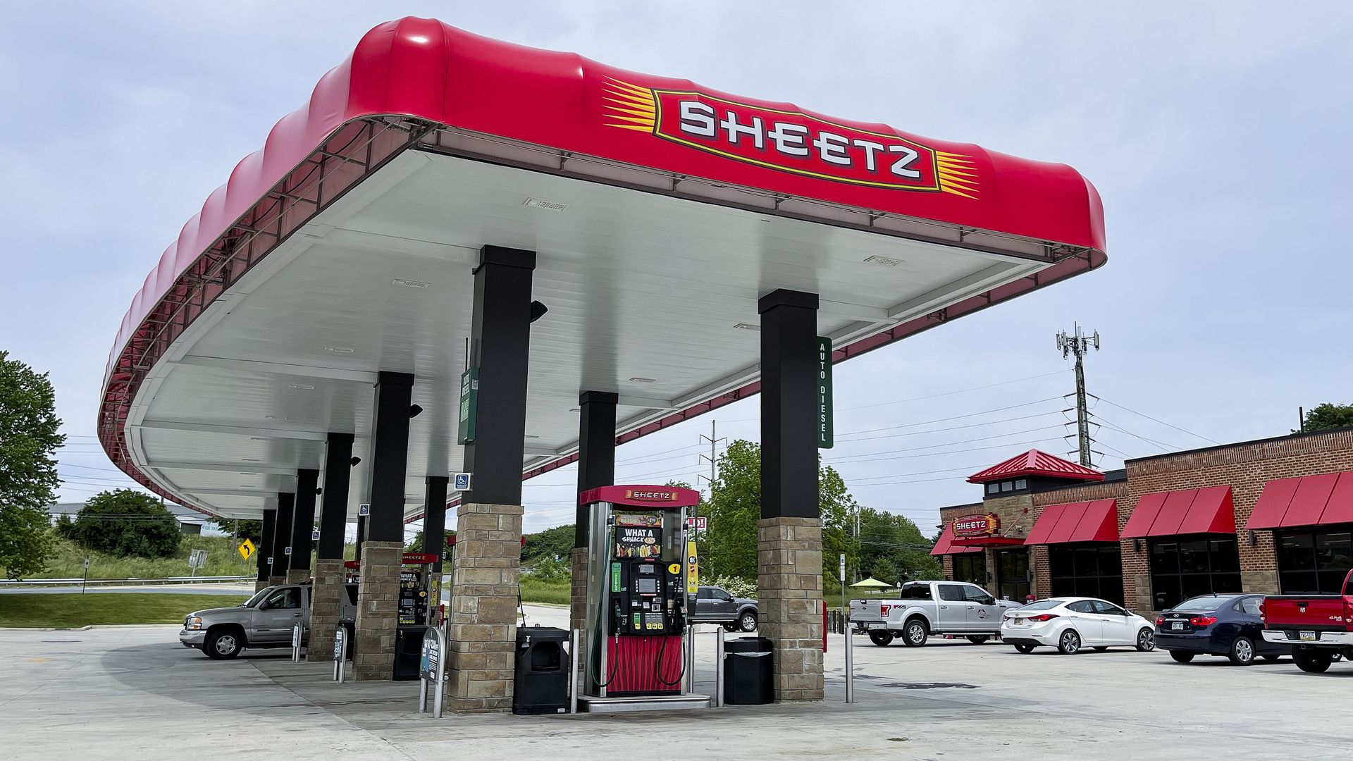 An overview of the pumps at a Sheetz gas station, with a red overhang