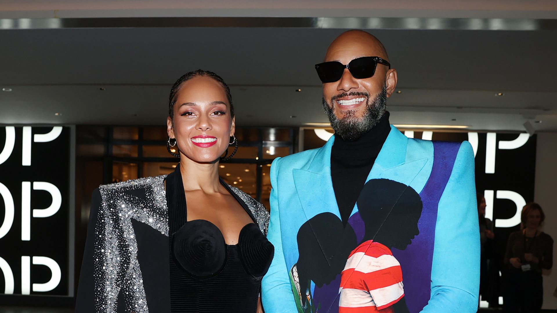 Alicia Keys and Swizz Beatz smiling at the camera