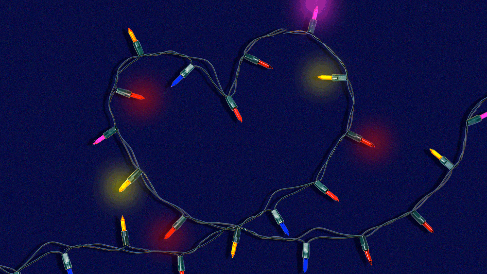 rainbow string lights in the shape of a heart blinking on and off