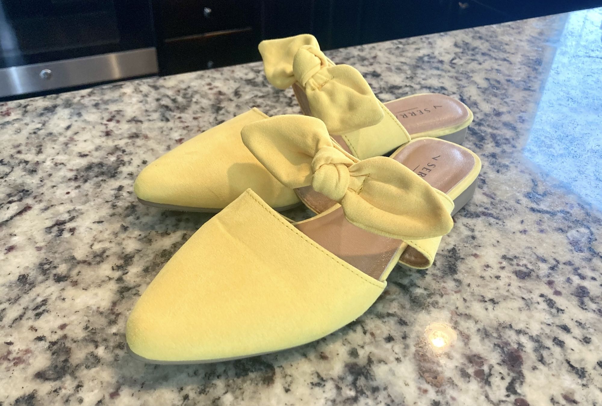 Yellow shoes with a bow.