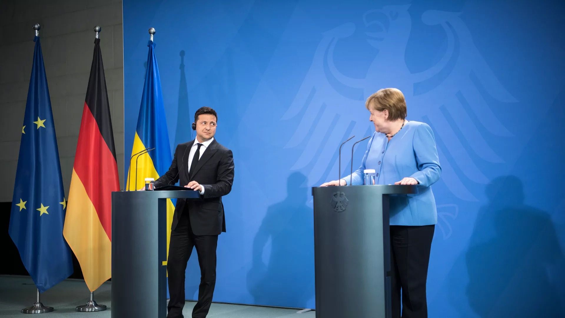 Ukrainian President Volodymyr Zelensky and German Chancellor Angela Merkel are seen during a news conference.