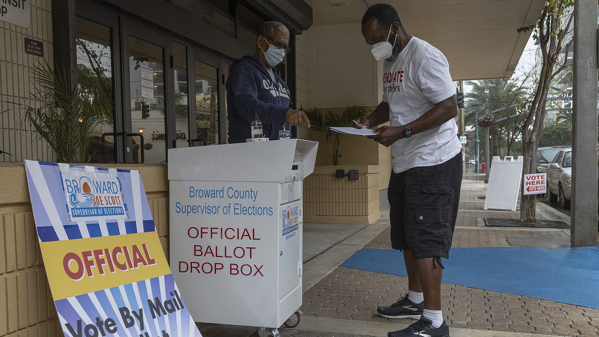 Wilbur Harbin prepares to place his ballot in a vote by mail ballot drop box during the Congressional district 20 elections on January 11, 2022 in Ft. Lauderdale, Florida.