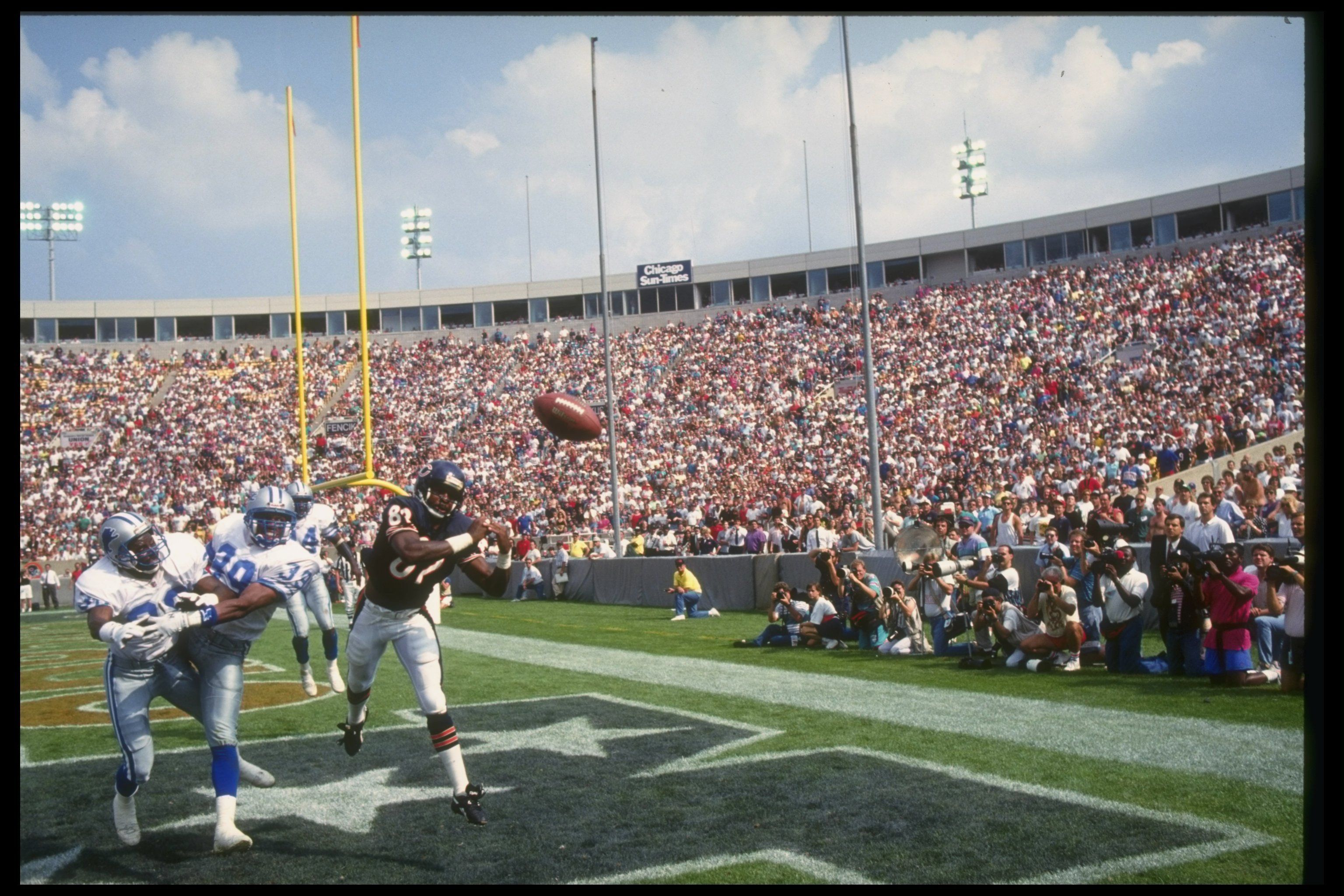 Photo of a player trying to catch a football during a game 