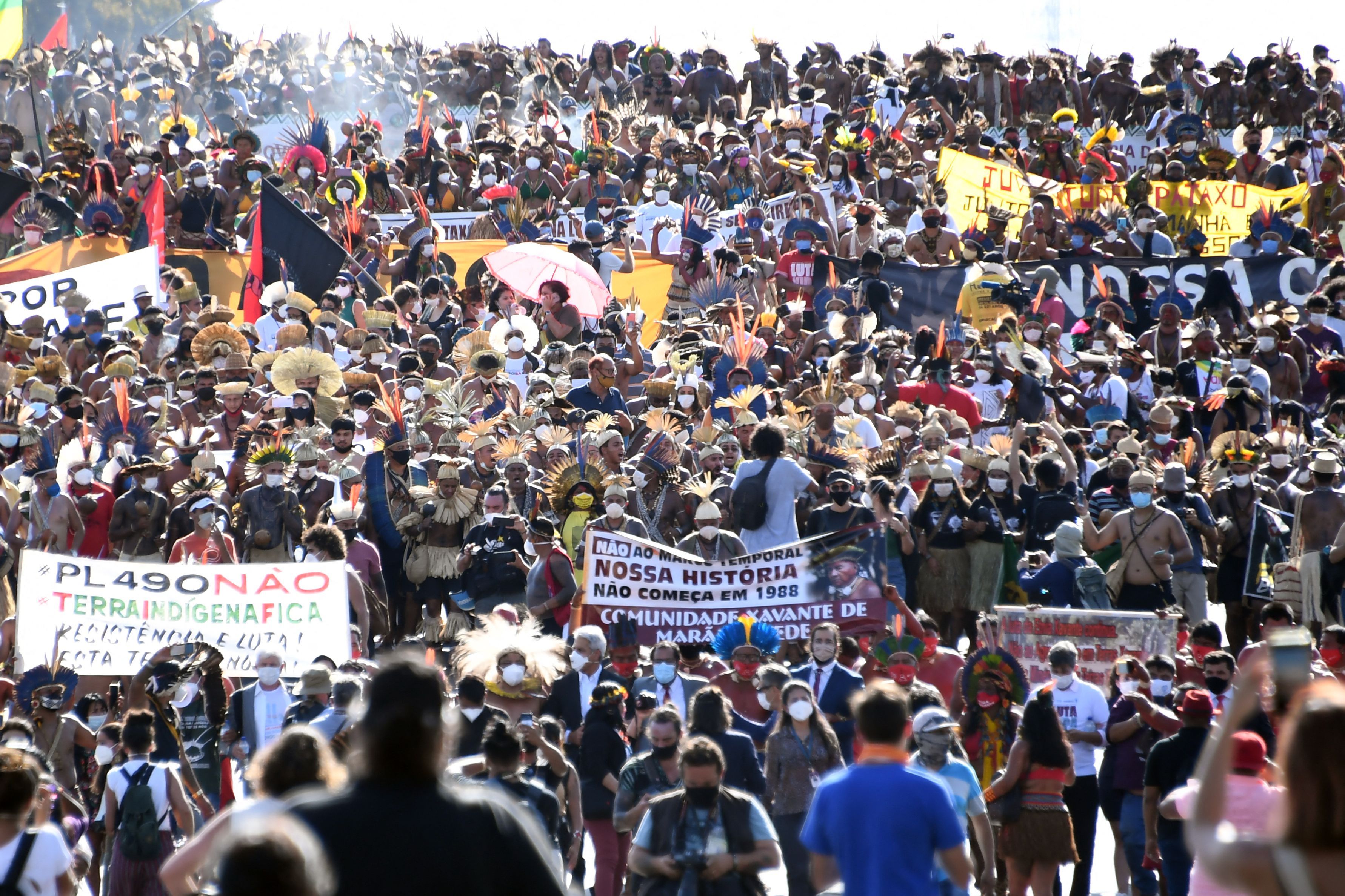 Photo of a massive crowd of Indigenous protesters, holding banners and signs