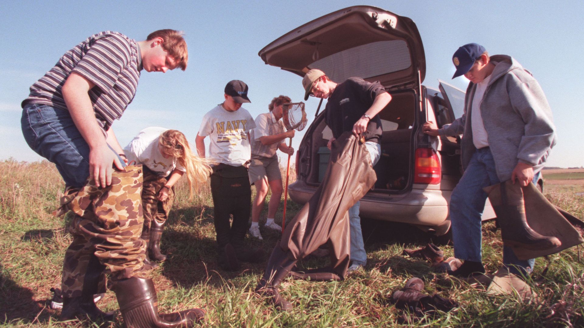 Students put on waders to search for frogs in a 1997 photo