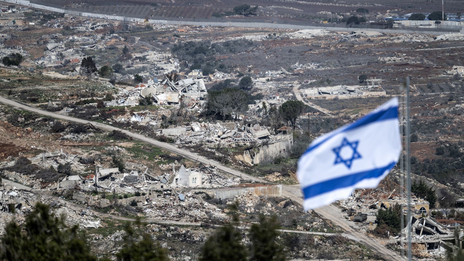 Israeli flag and rubble