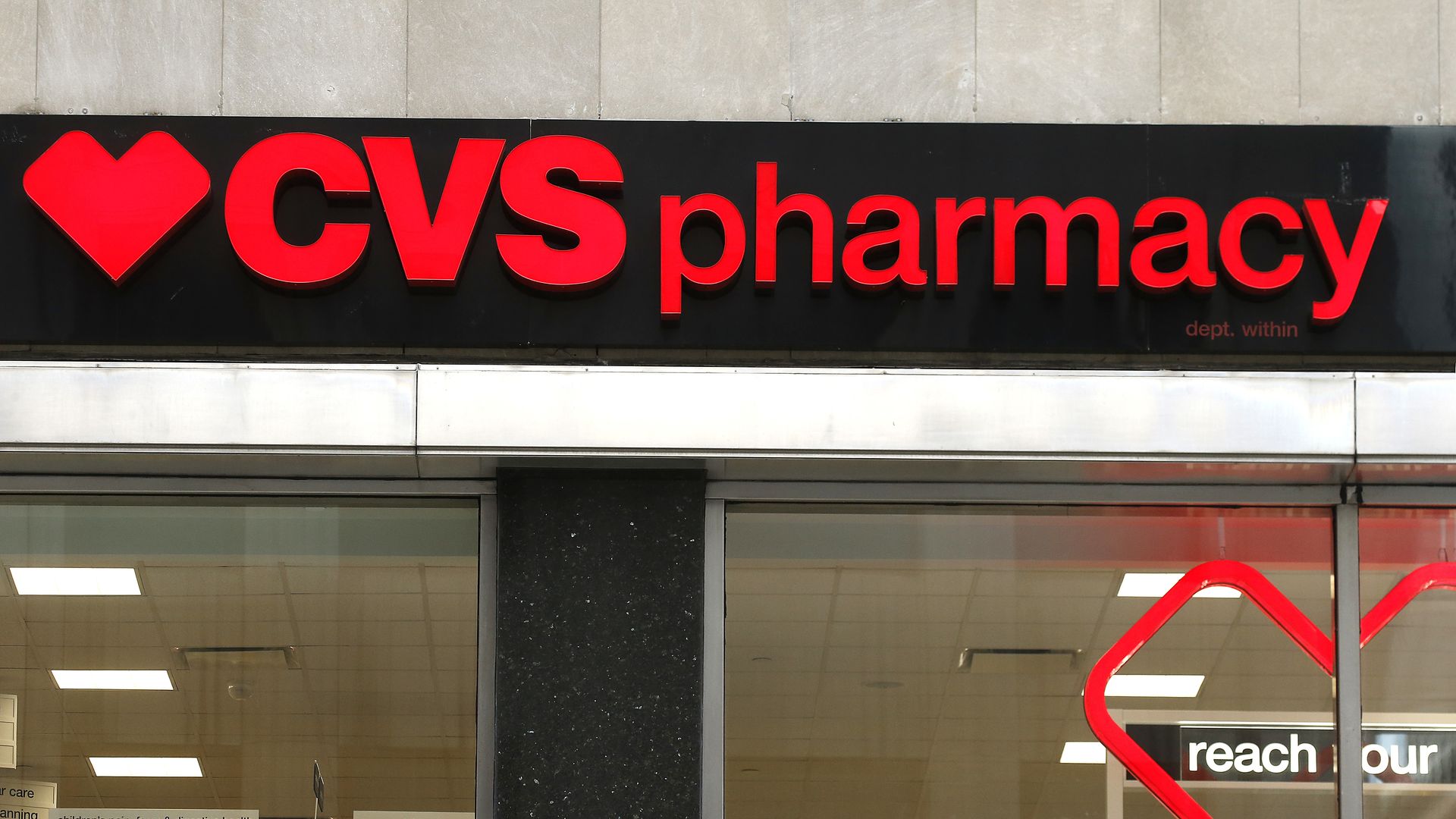 The red "CVS pharmacy" logo atop a CVS store.
