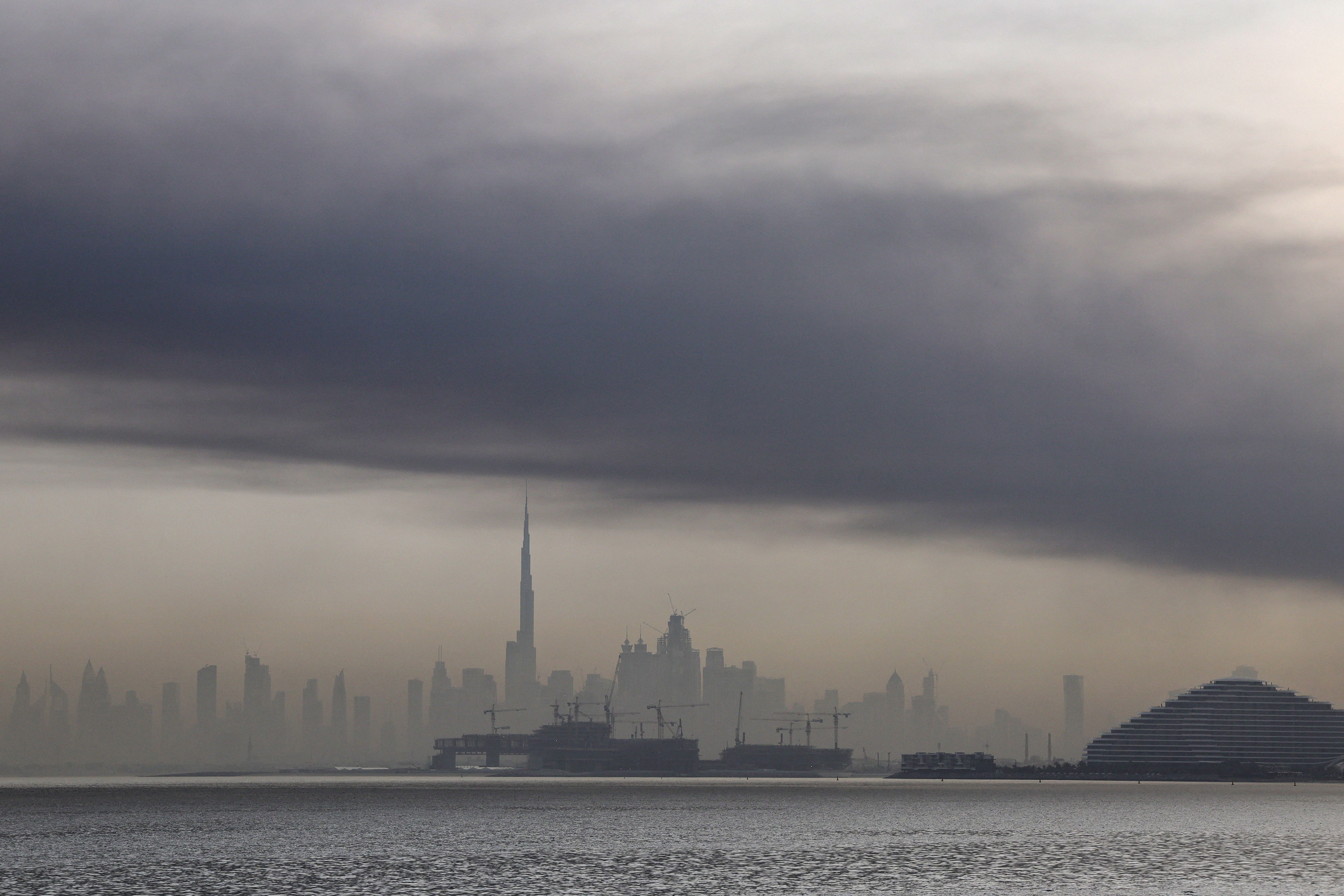 TOPSHOT - Smoke is seen above Dubai on March 13, 2026. Explosions rattled buildings in Dubai and a large cloud of smoke hung over a central area of the Middle East financial hub on March 13, AFP correspondents said. (Photo by AFP via Getty Images) /