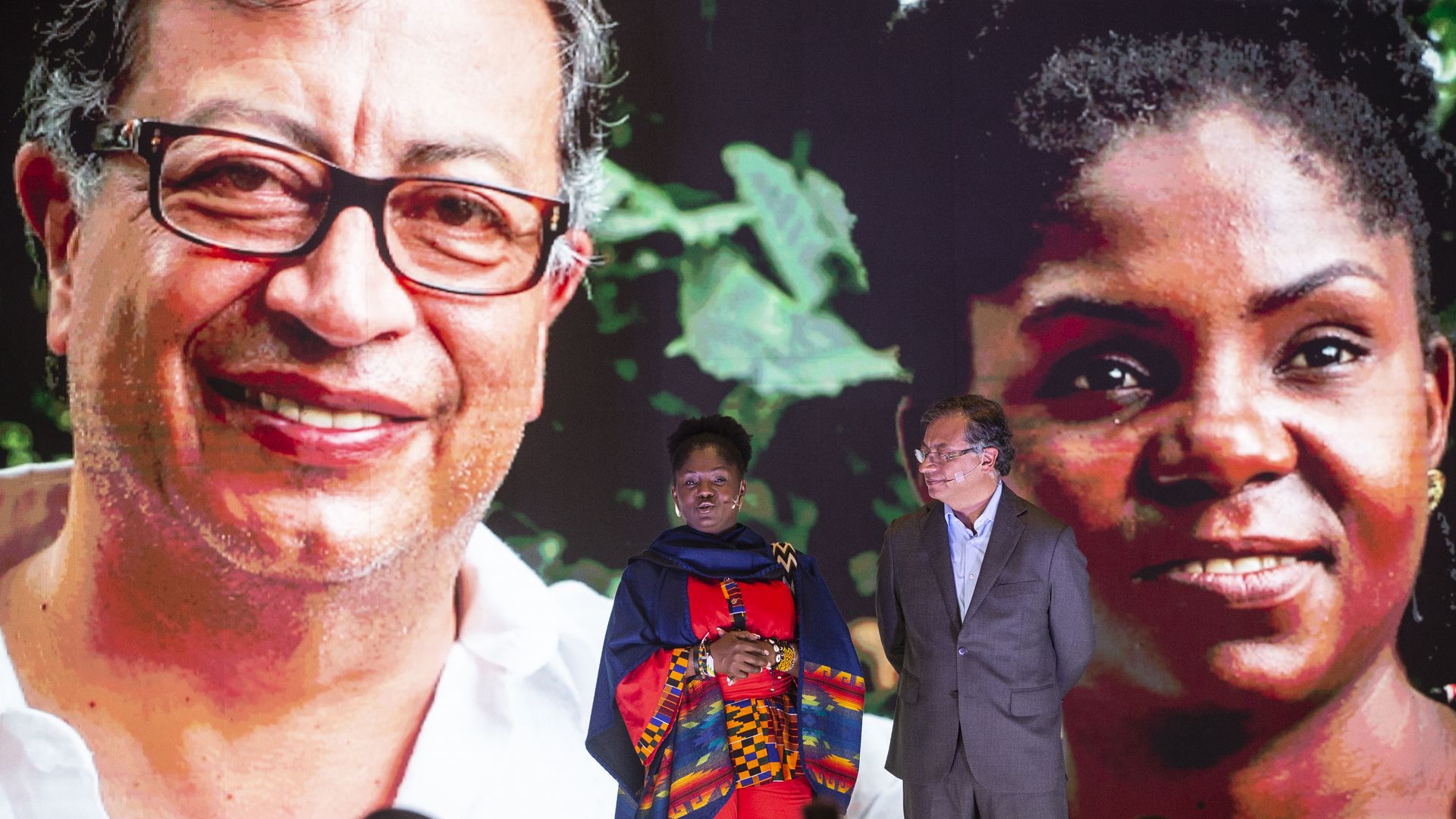  Francia Marquez, vice presidential candidate, stands to the left of presidential candidate Gustavo Petro,while large images of them project on a screen behind them. 