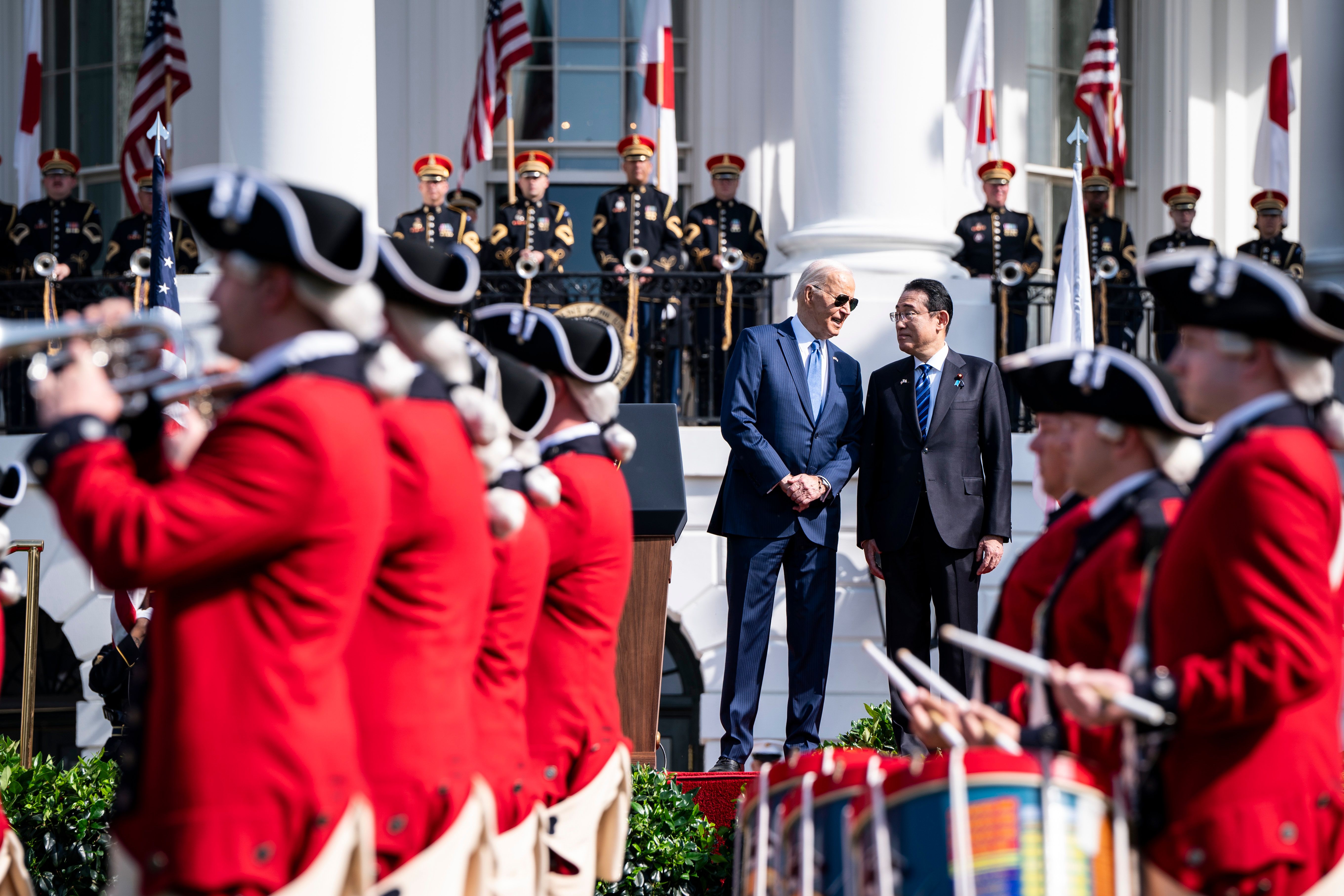 US President Joe Biden, center left, at an arrival ceremony with Fumio Kishida, Japan's prime minister, center right, during a state visit on the South Lawn of the White House in Washington, DC, US, on Wednesday, April 10, 2024. President Joe Biden and Japanese Prime Minister Fumio Kishida have enlisted Amazon.com Inc. and Nvidia Corp. to fund a new joint artificial intelligence research program, as the two nations look to improve collaboration around the quickly emerging technology. 