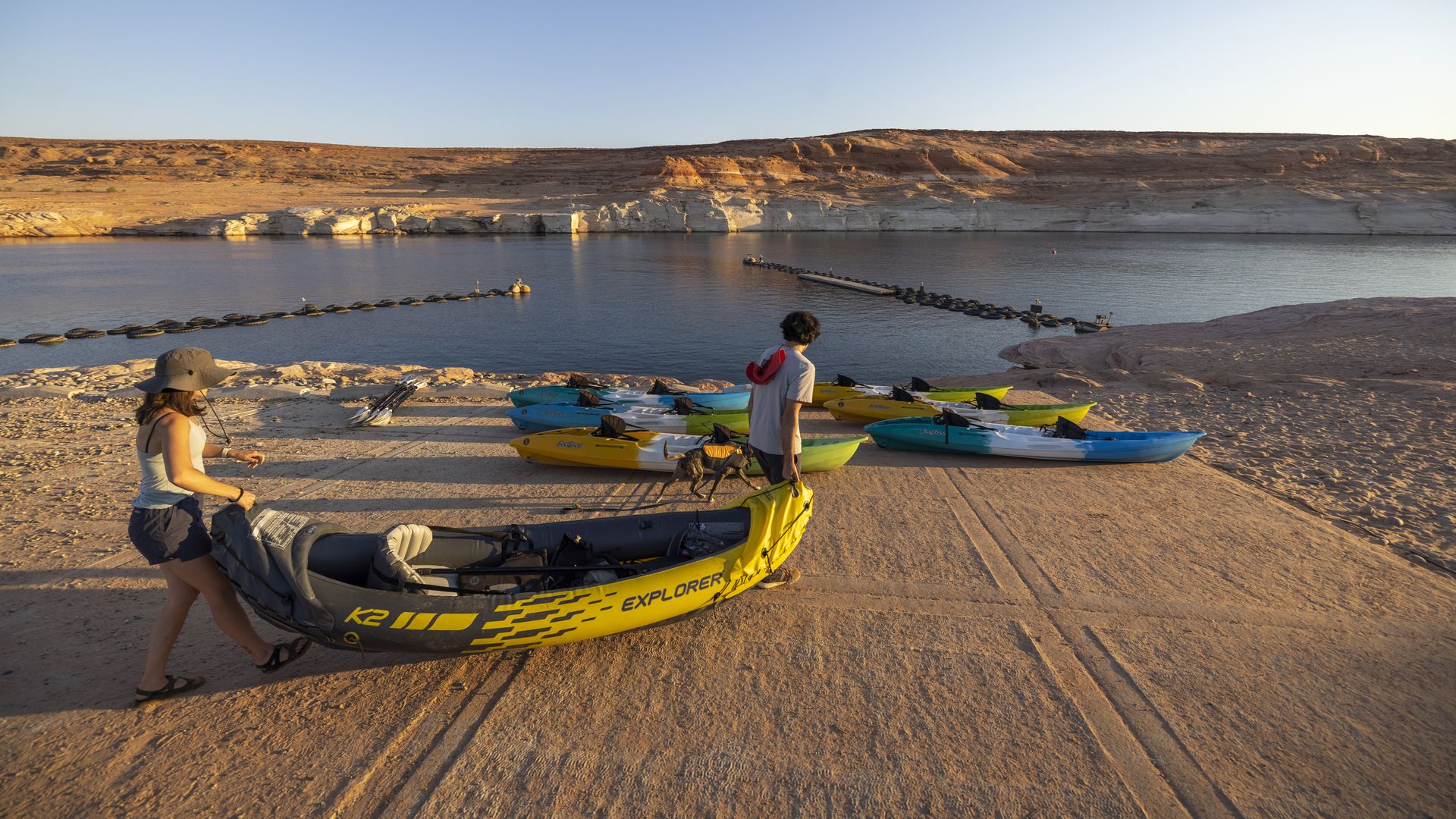  Kayakers climb down the drop-off below the Antelope Point boat launch ramp which was made unusable by record low water levels at Lake Powell as the drought continues July 3, 2021 near Page, Arizona. 