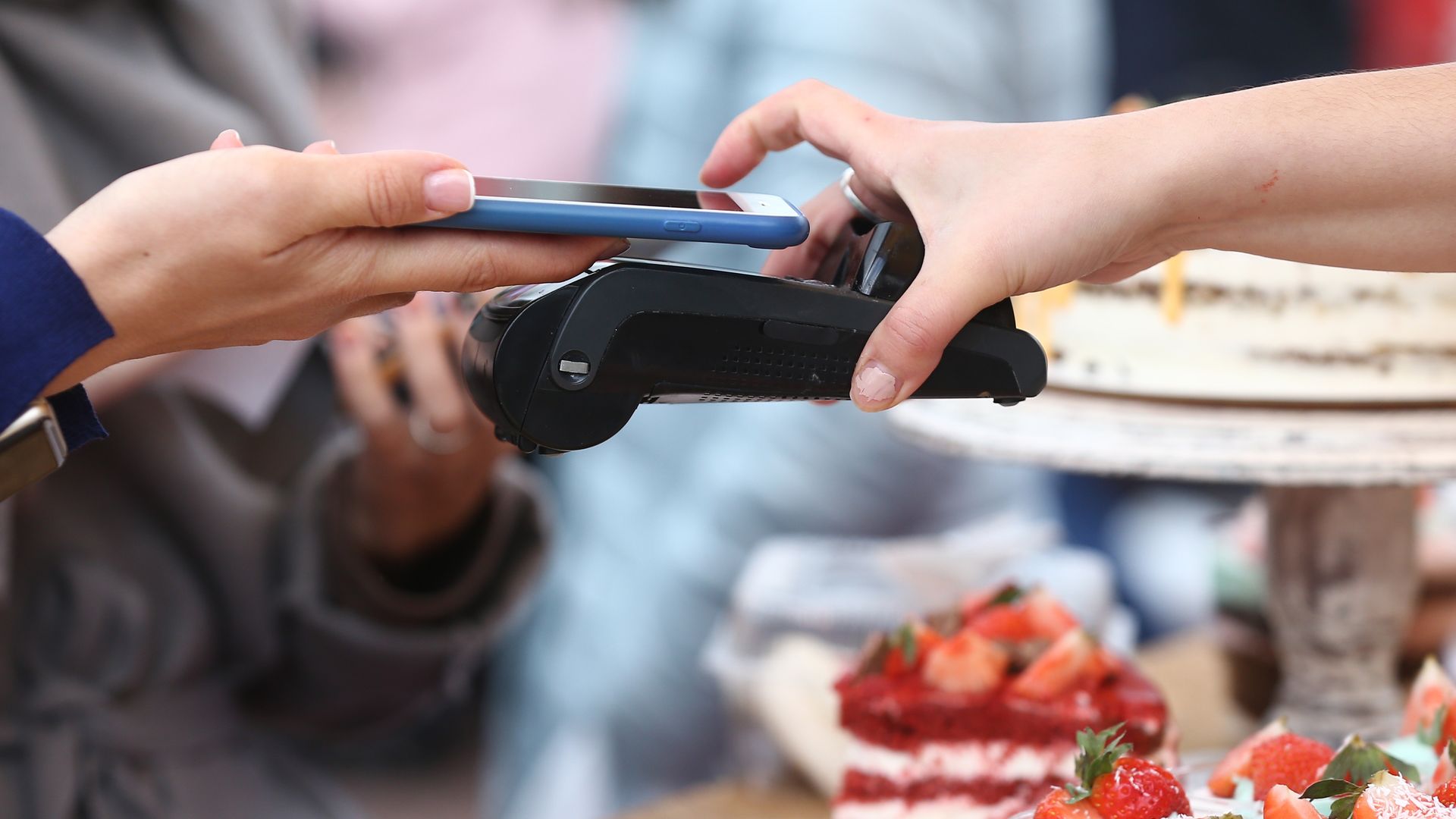 A person pays for something with an iPhone