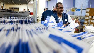 Denver election judge Andre Jefferson sorts ballots Election Day. Photo: Michael Ciaglo/Getty Images