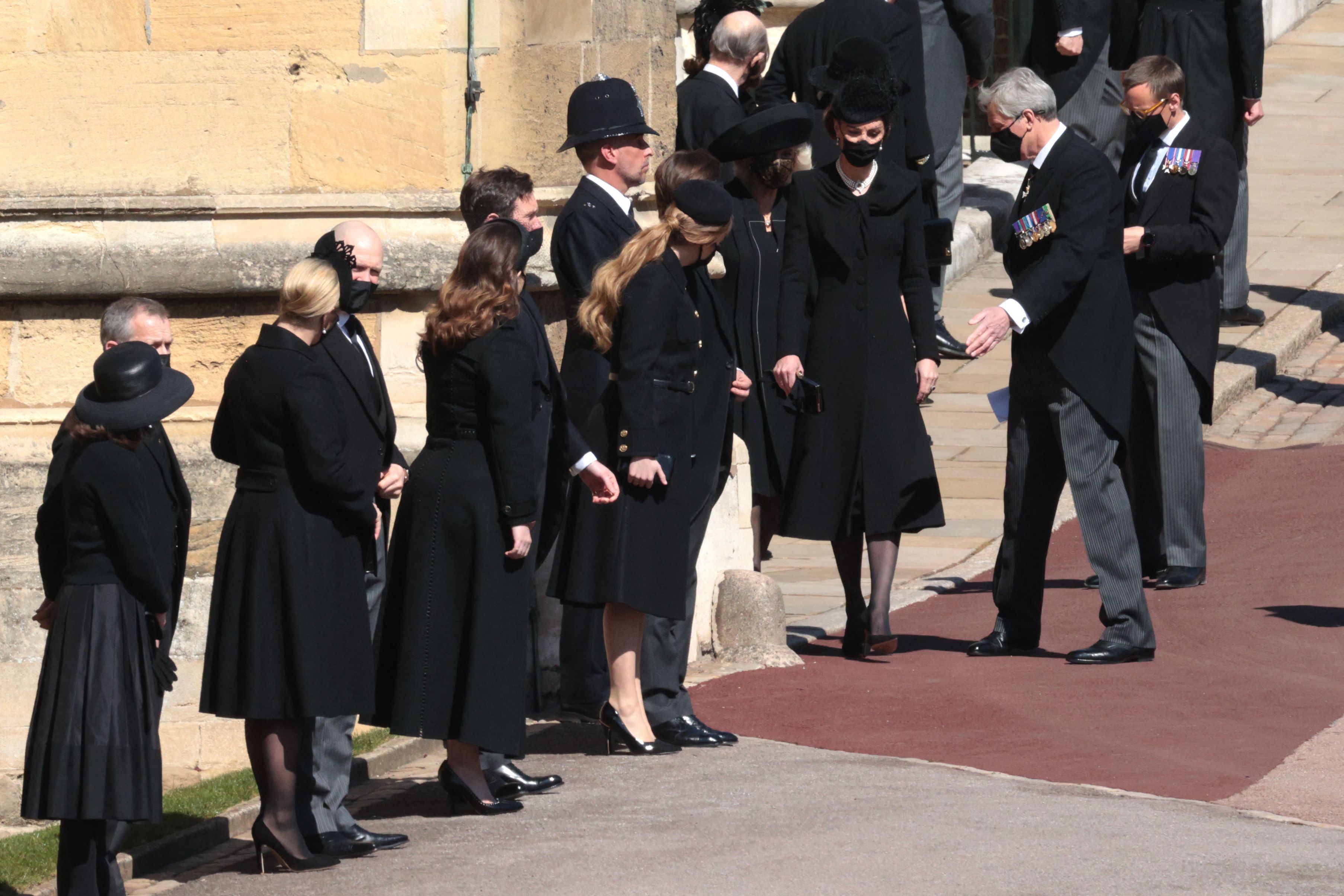 Picture of members of the royal family wearing all black and standing in line