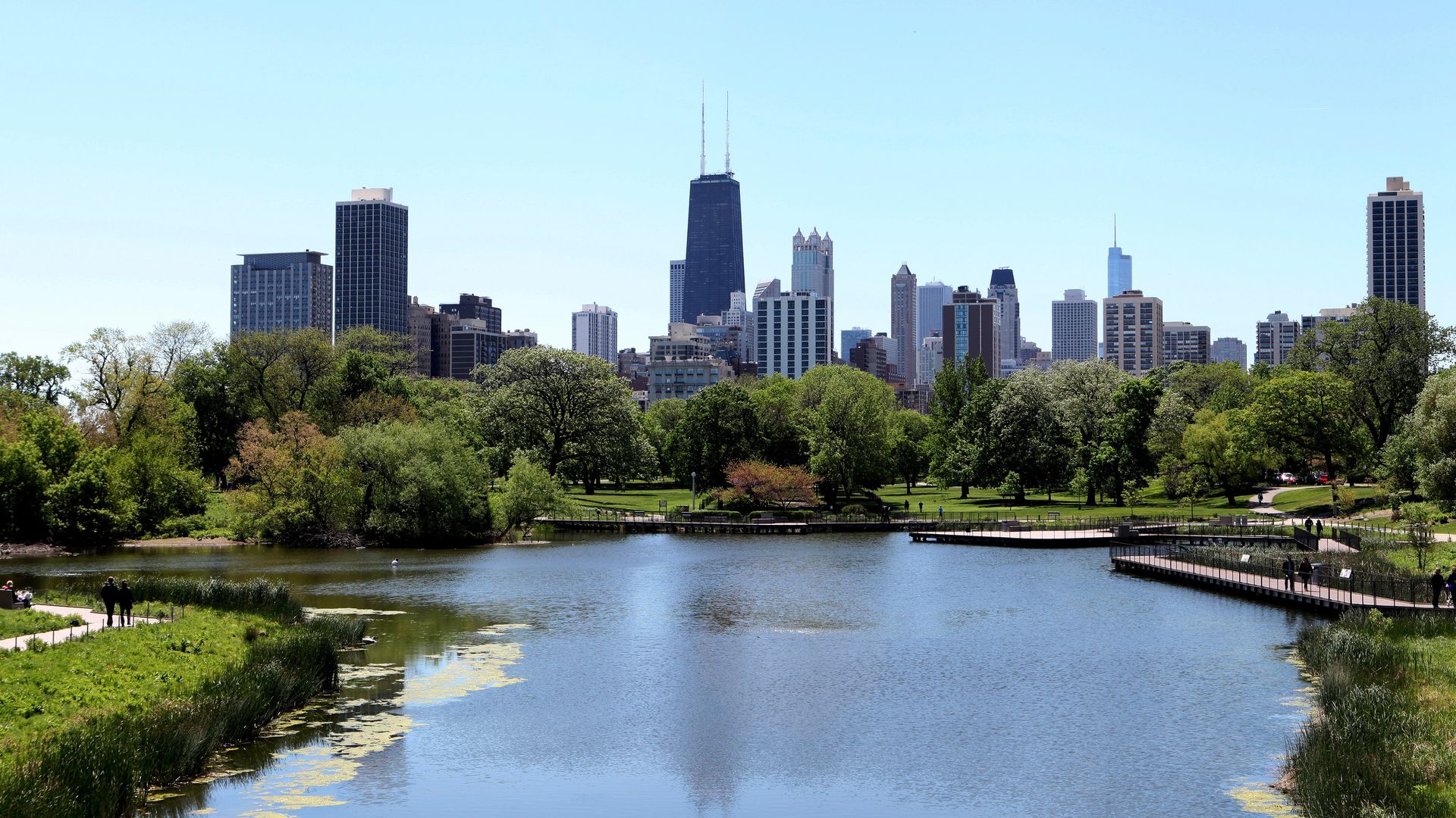Photo of a body of water with a city skyline behind it 