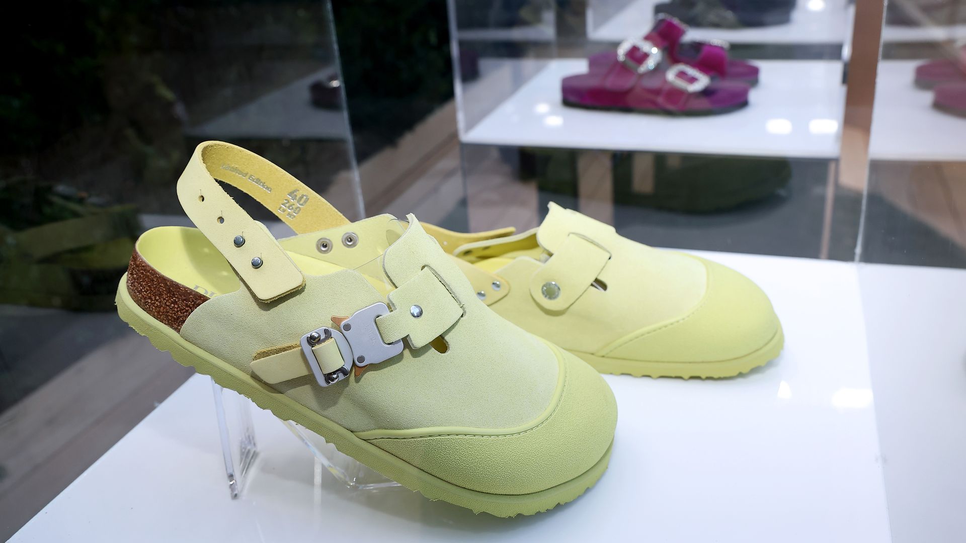 A pair of Birkenstock sandals sit in a display box.