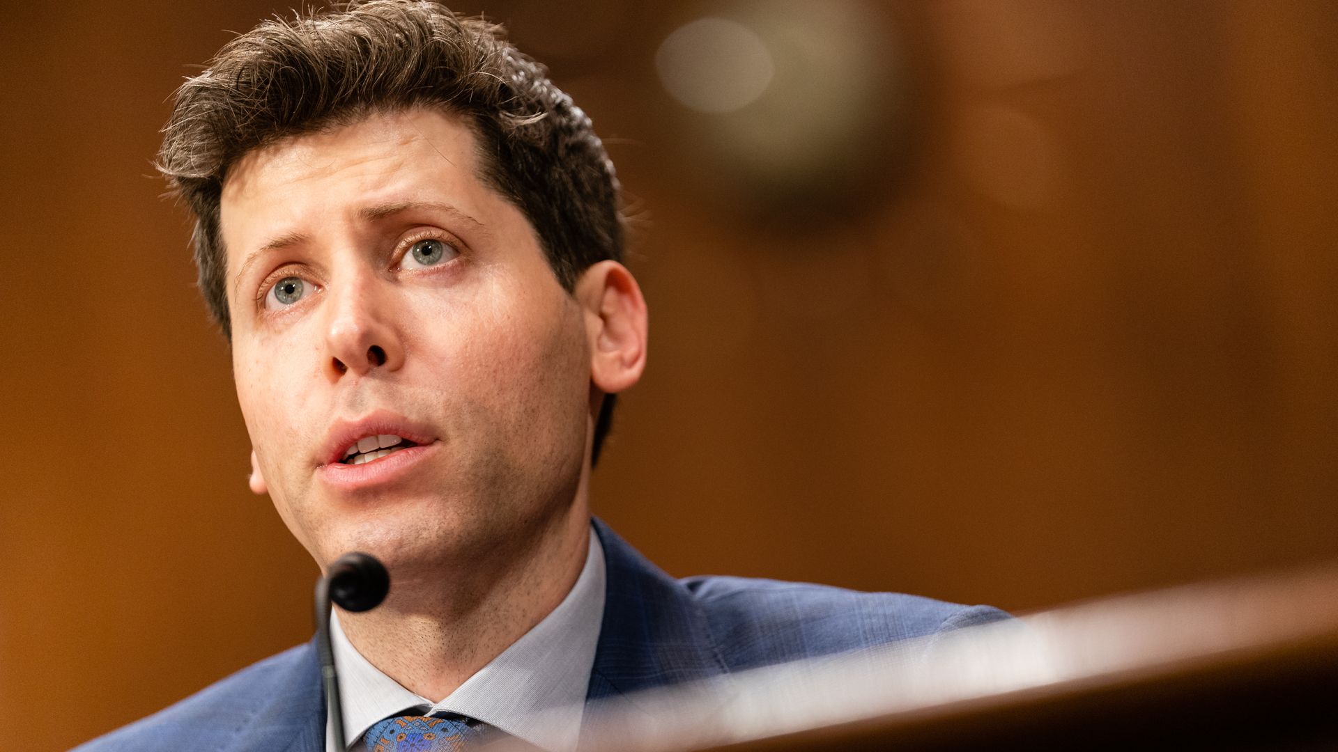 A person in front of a microphone during a congressional hearing