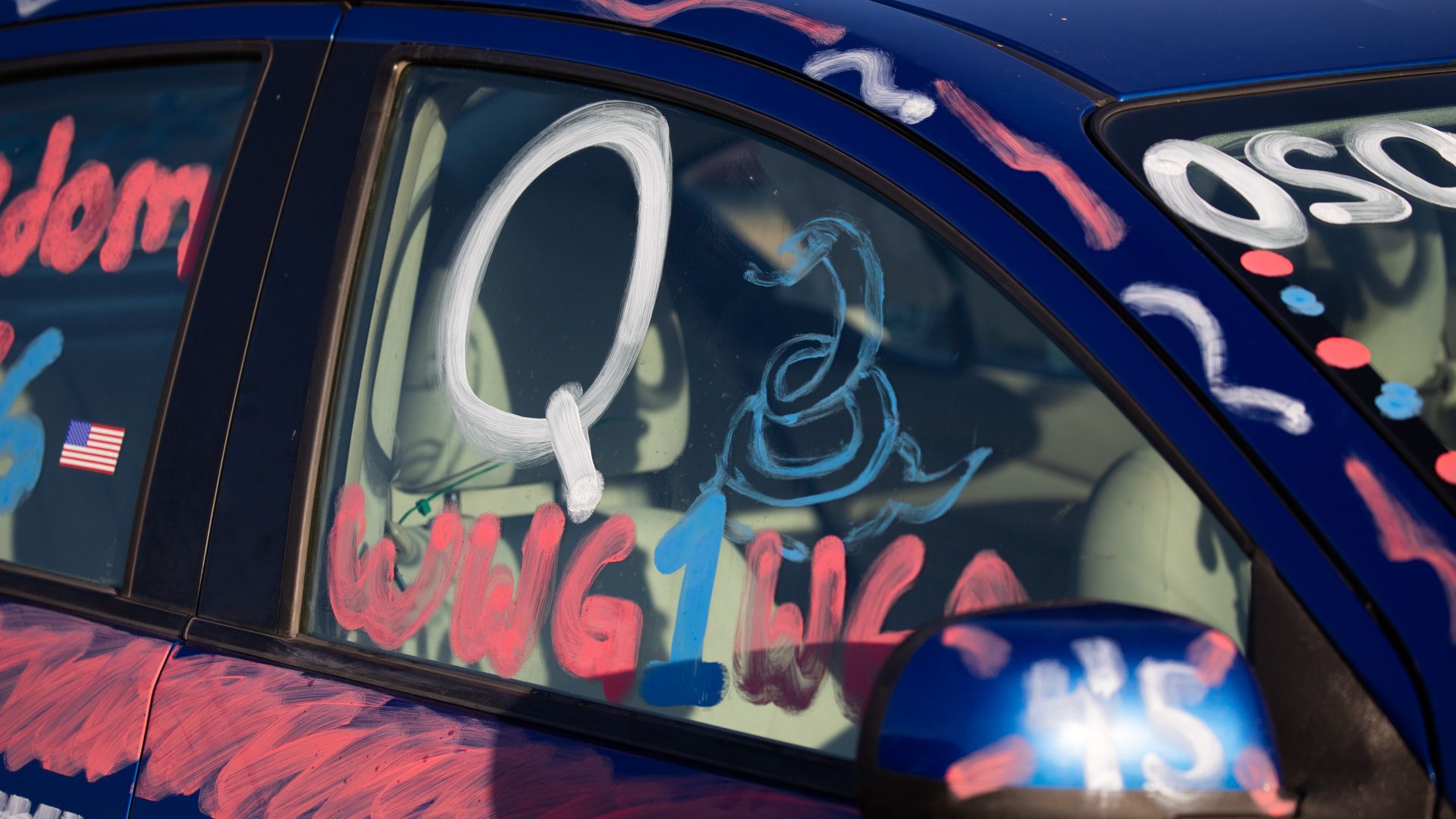 A Q and WWG1WGA painted on the window of a car