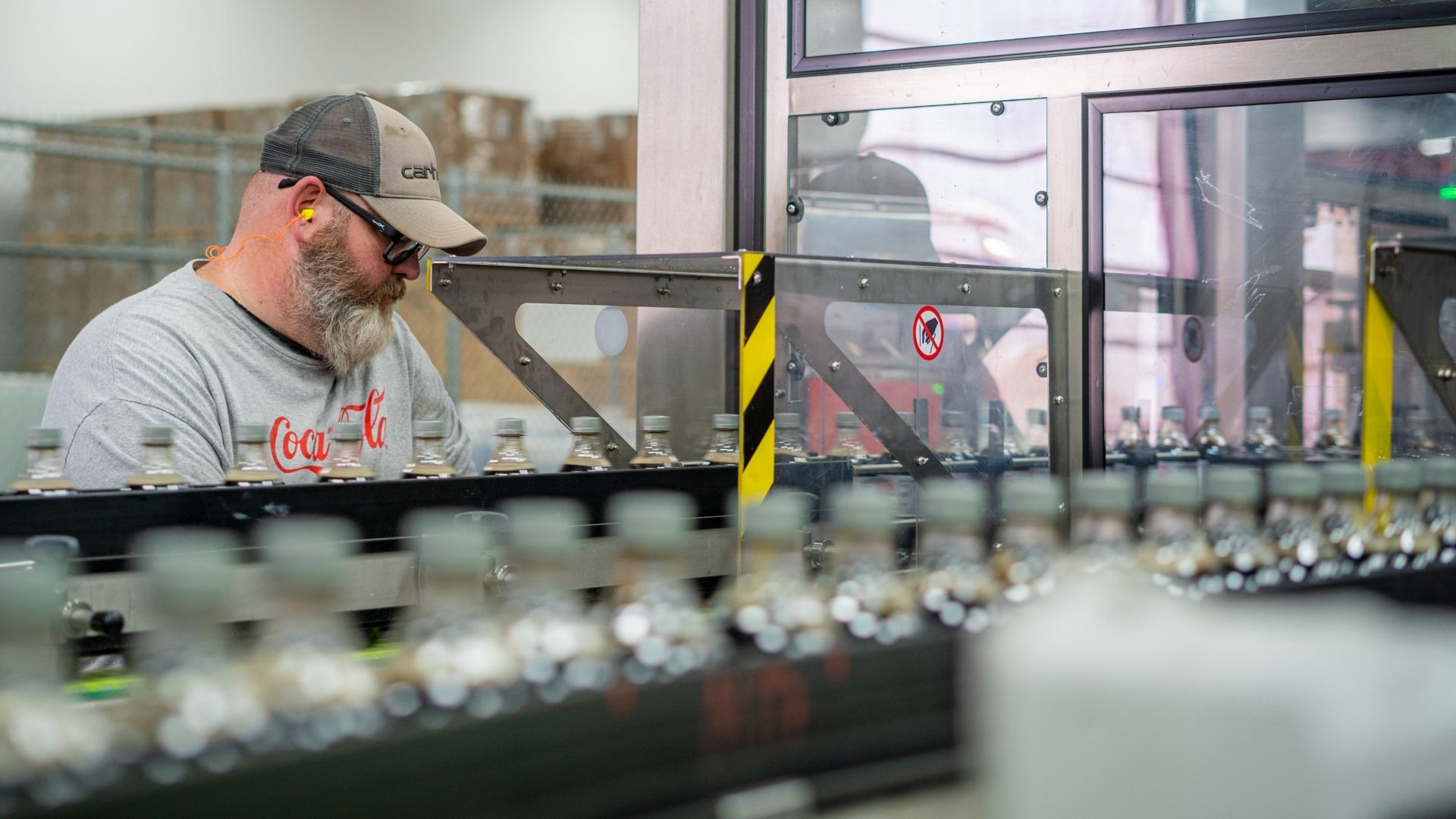 A male worker at a processing plant.