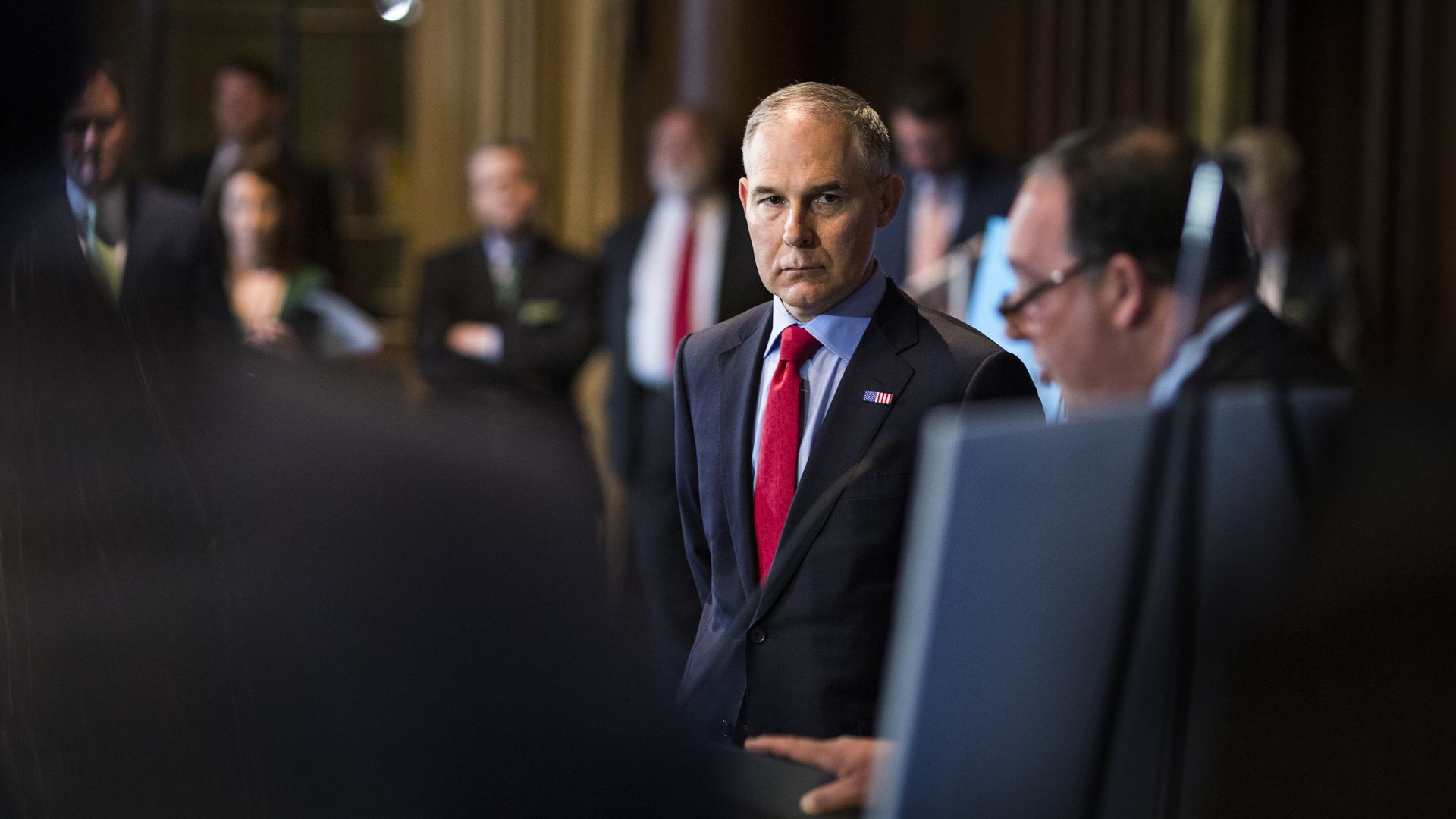Scott Pruitt looks out the side of his eyes at a presentation.