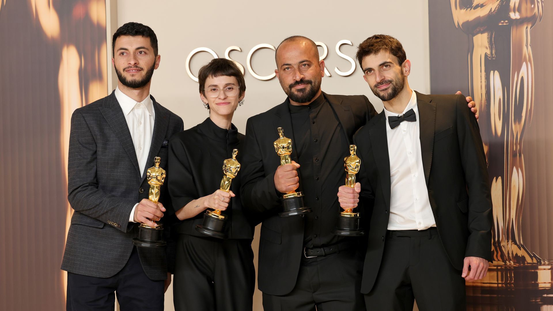 The "No Other Land" team poses with their Academy Awards for best documentary feature