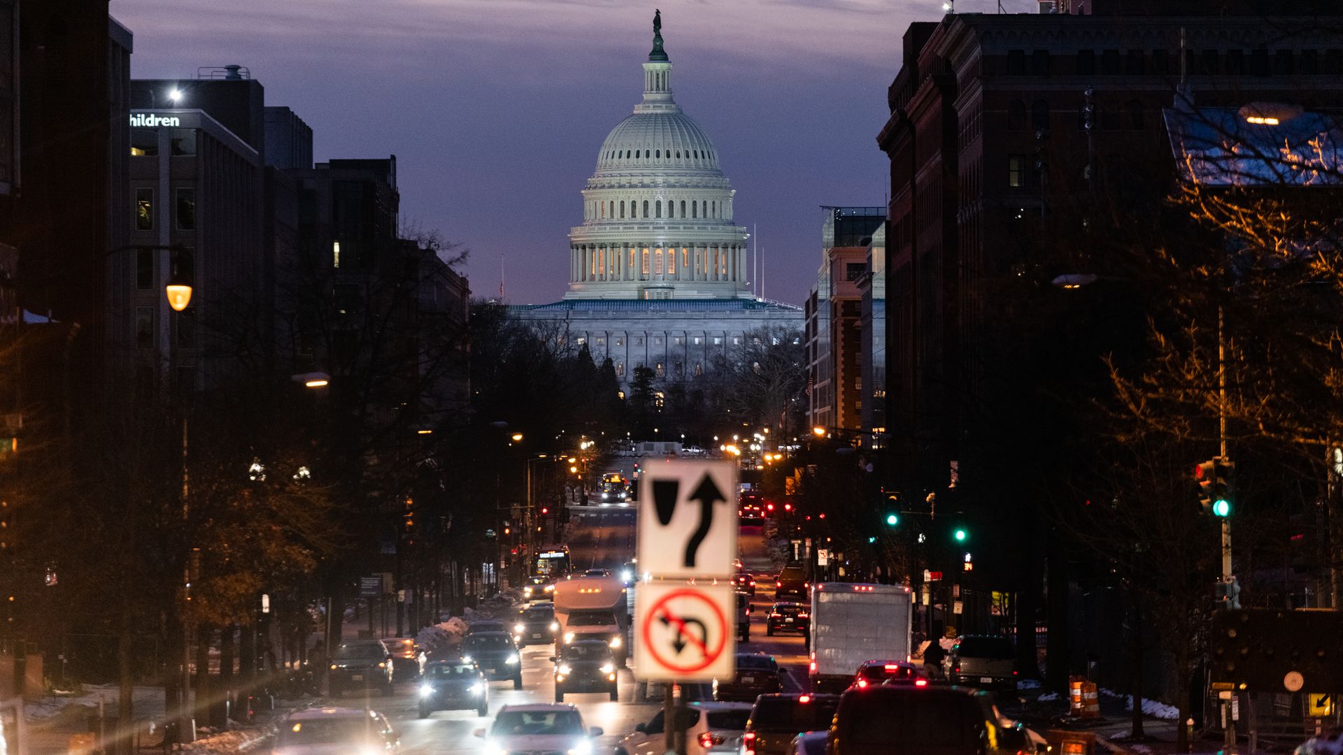Traffic with the Capitol in the background.