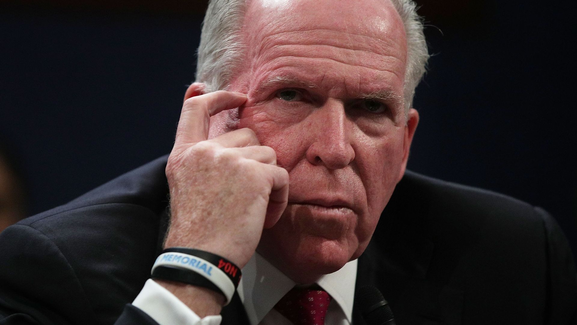 John Brennan with hand resting on side of his head, looking contemplative