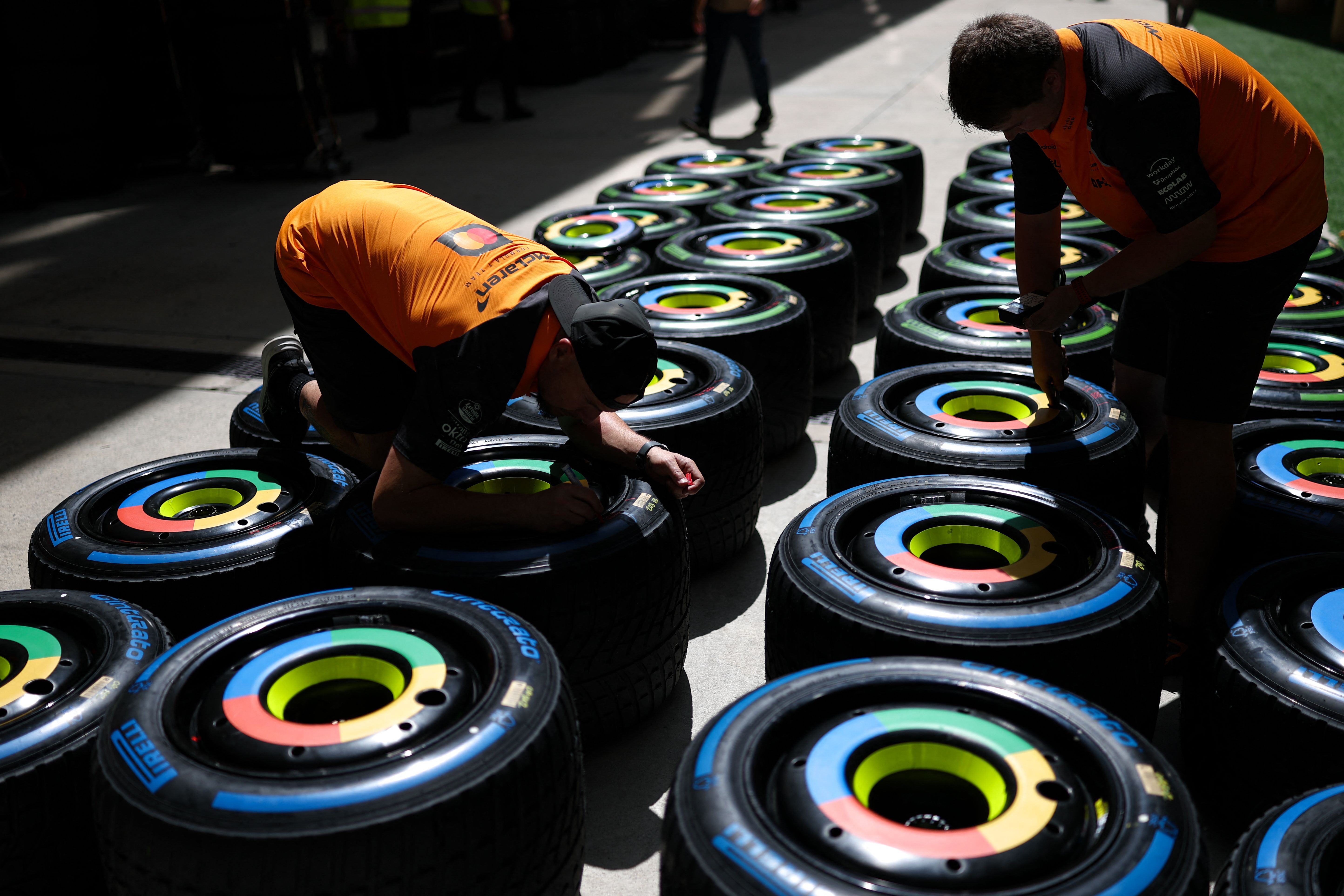 Members of the McLaren Formula One team check the tires in the paddock ahead of the 2025 Miami Formula One Grand Prix at Miami International Autodrome in Miami Gardens, Florida, on May 1, 2025. (Photo by CHARLY TRIBALLEAU / AFP) (Photo by CHARLY TRIBALLEAU/AFP via Getty Images)